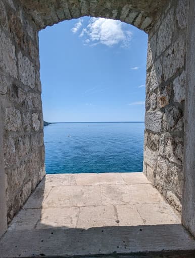 View of sea through stone peep hole.
