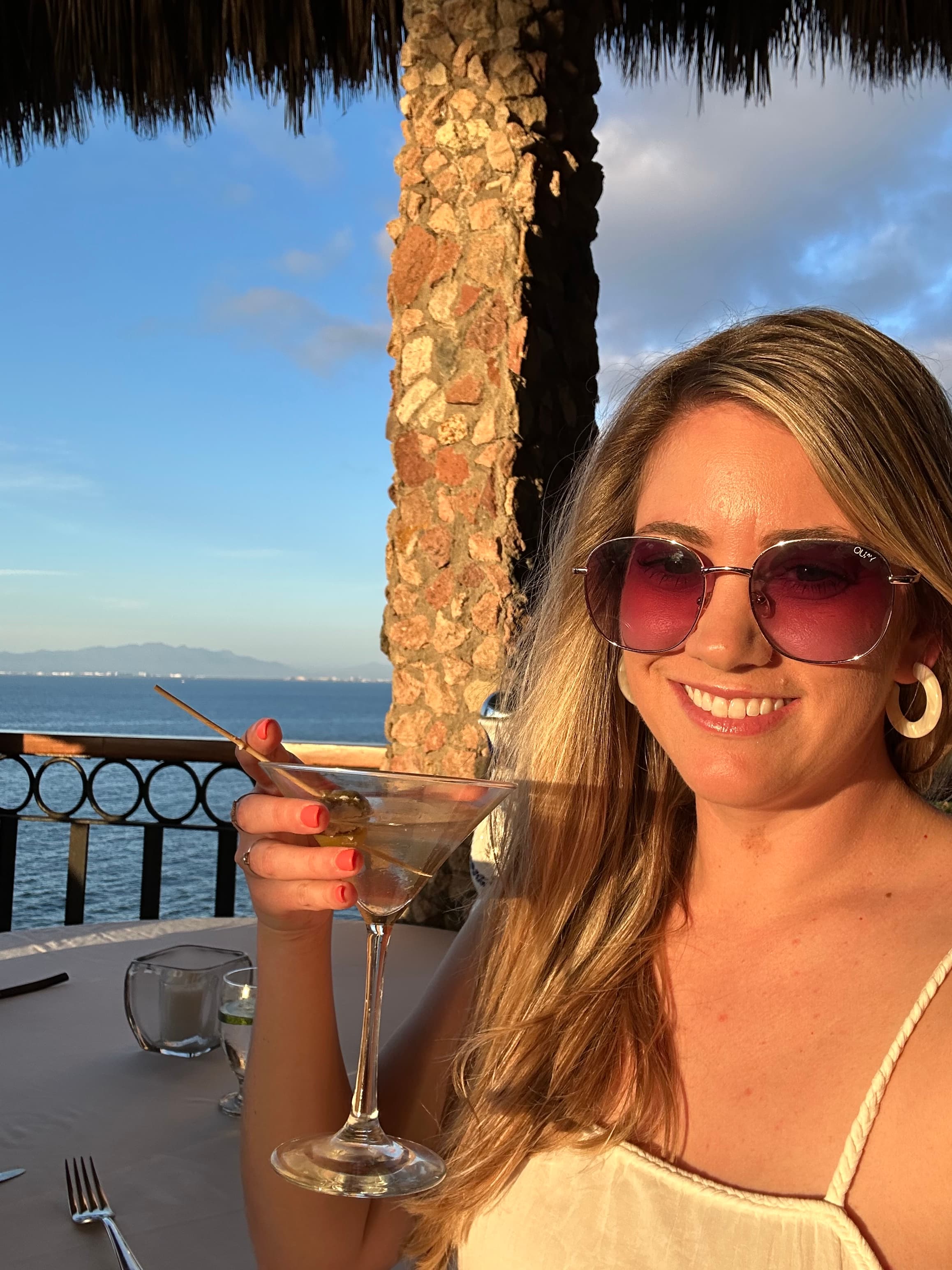 Travel advisor holding a cocktail