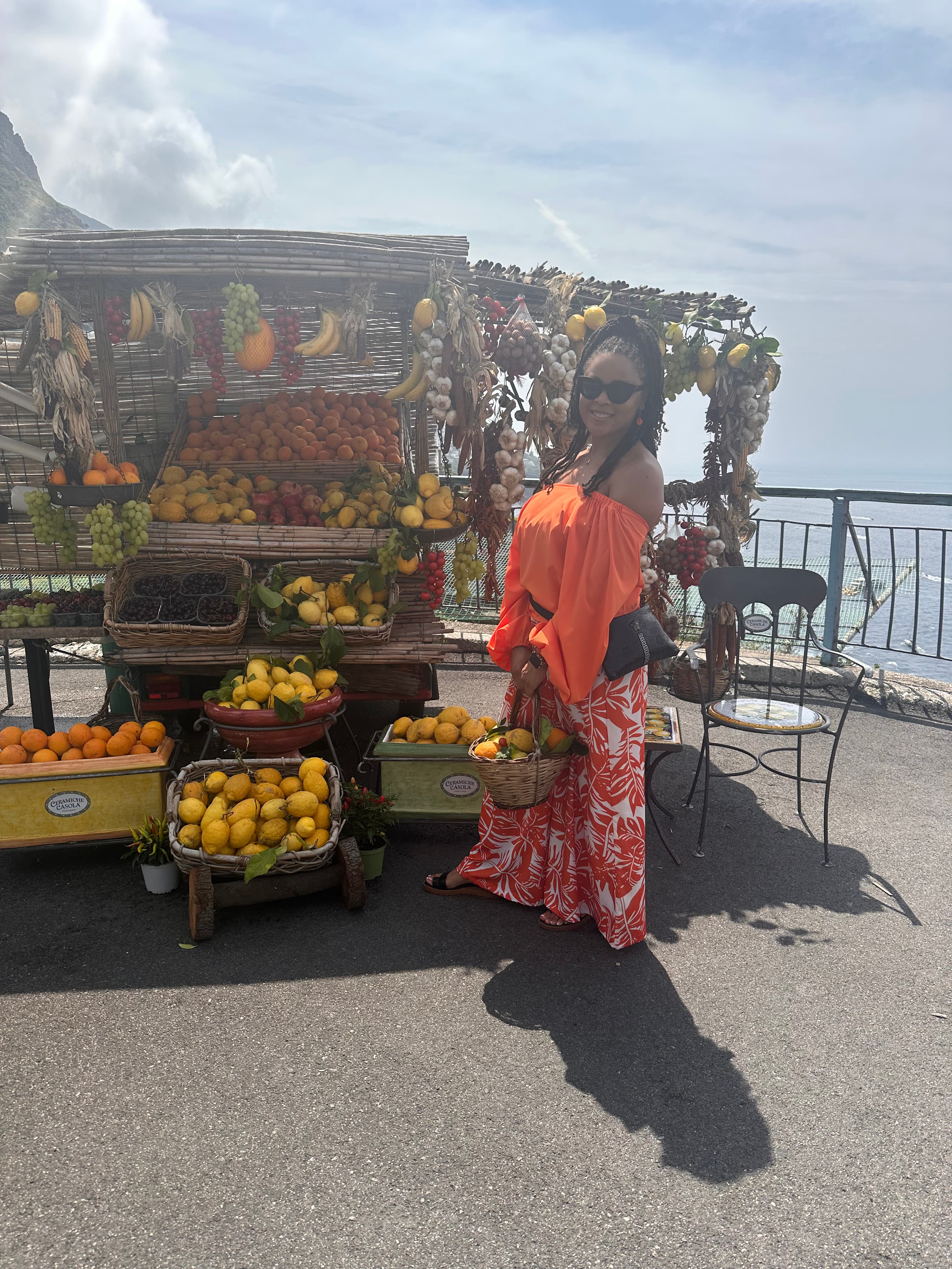Posing by a fruit cart