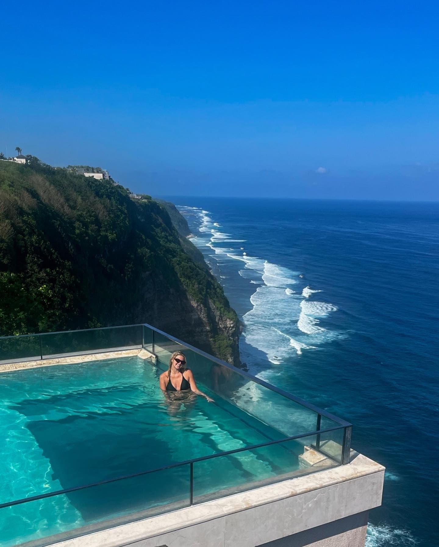 Travel advisor posing on a sea side pool