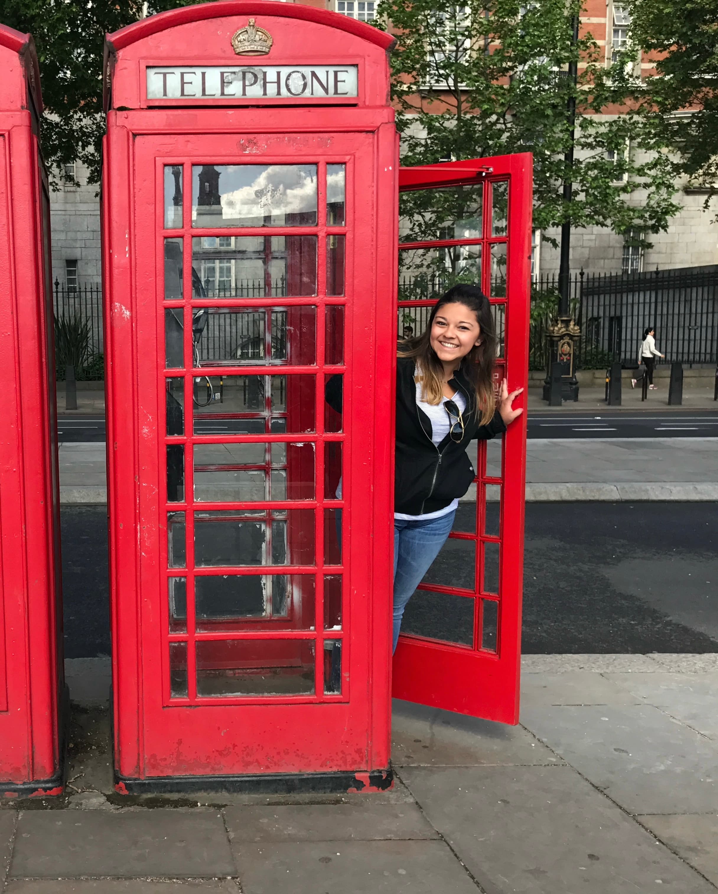Lexy in a red telephone booth in London
