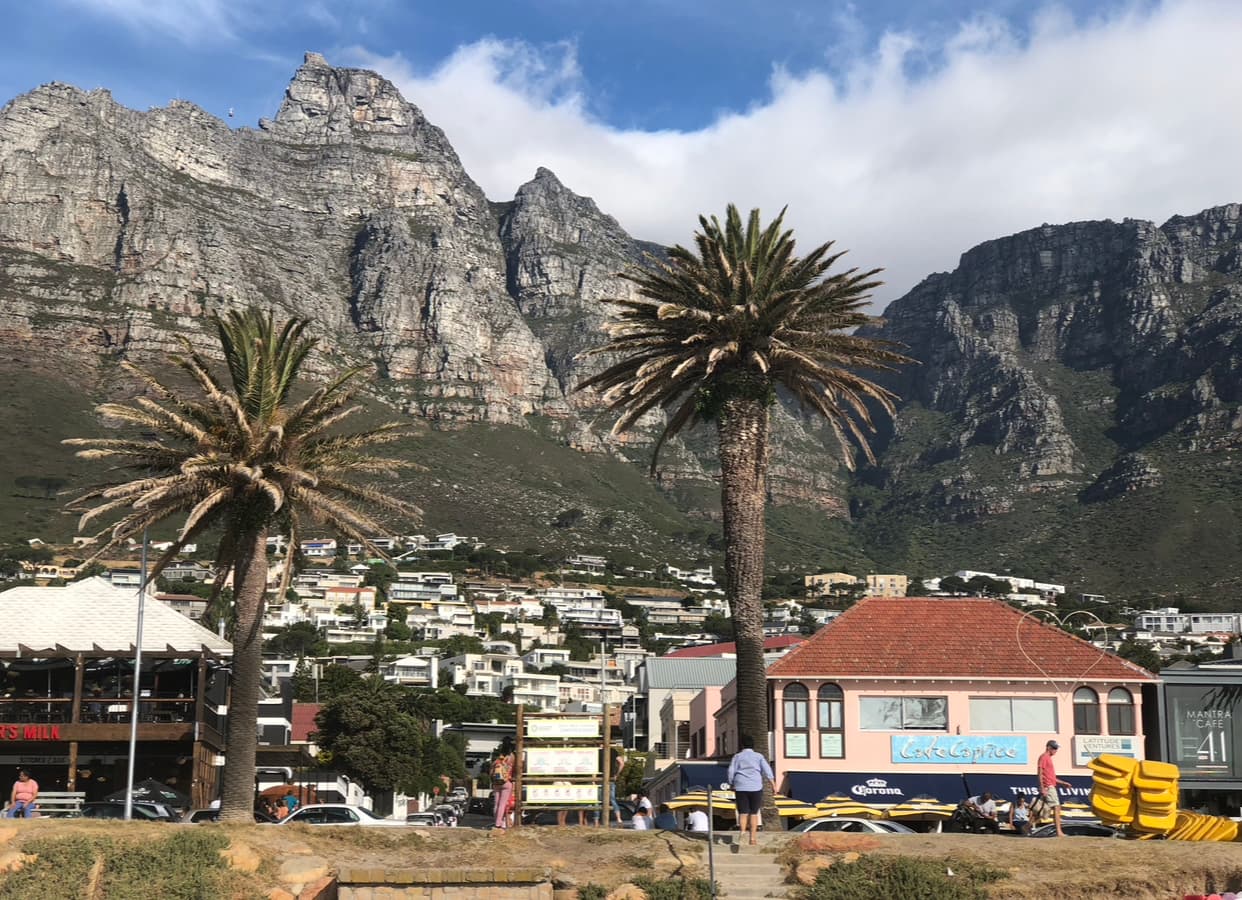 Beach-style houses in a town surrounded by rocky mountains