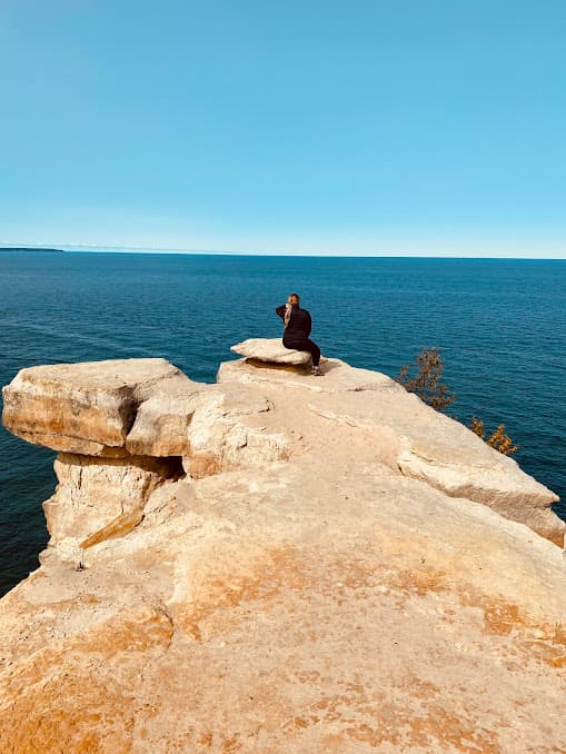 sitting on a cliff