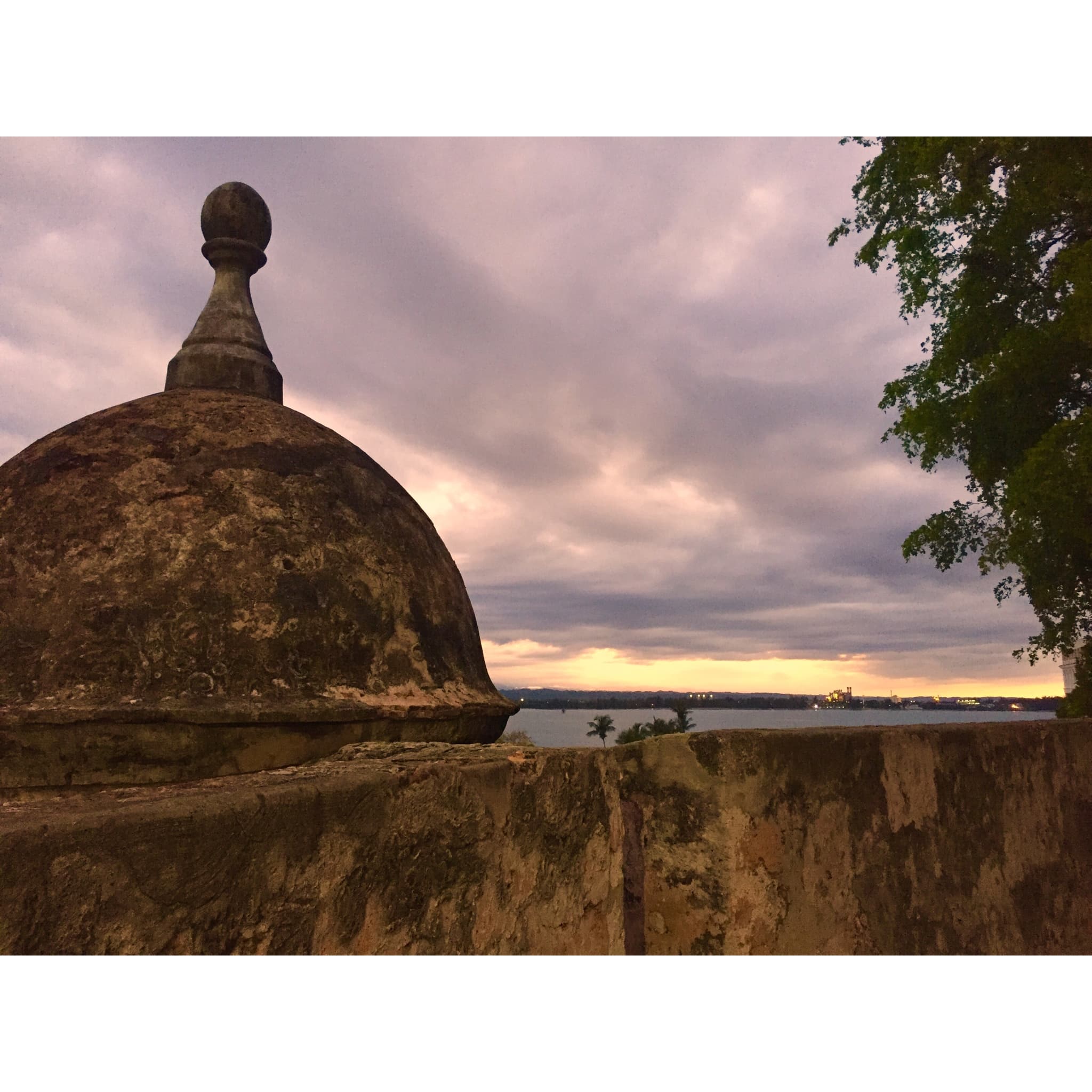 The sunset over a large cement structure