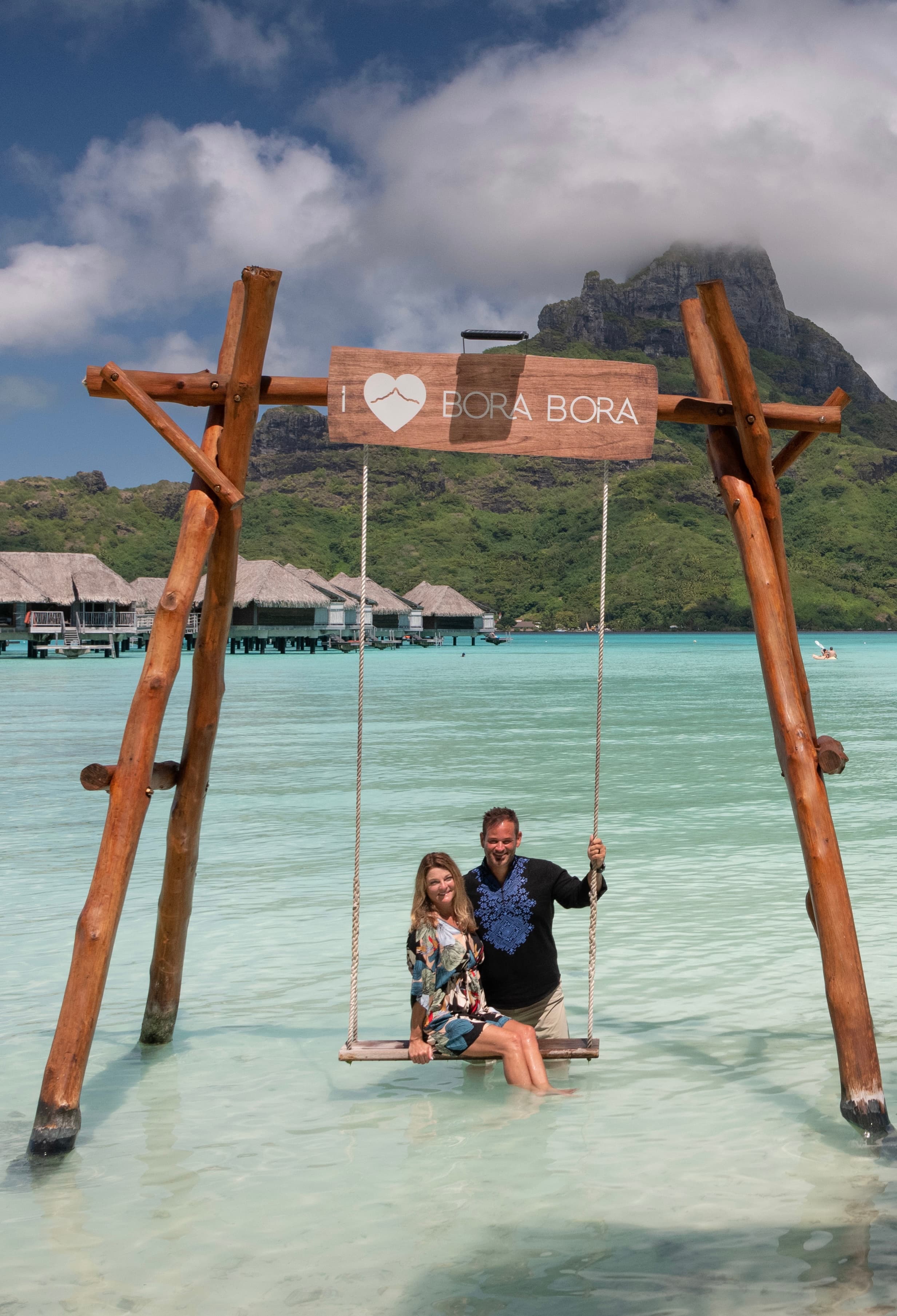 Couple on a swing over the sea