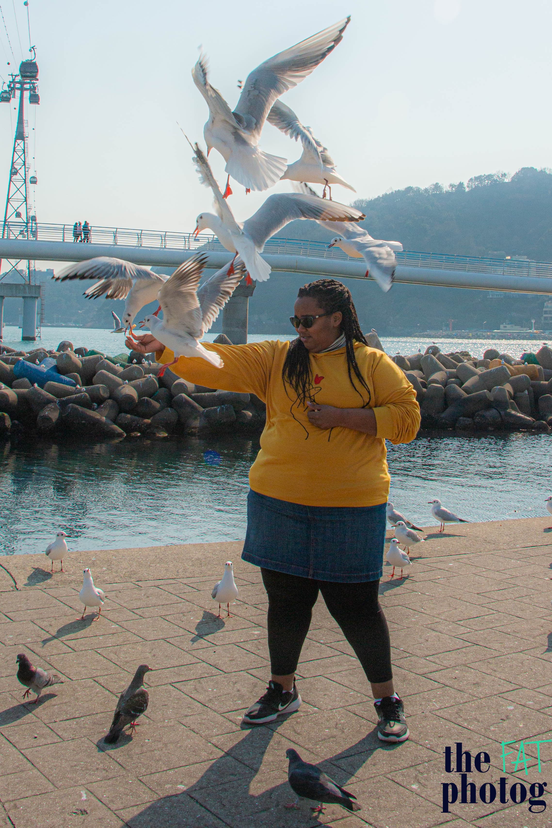 Laure posing with birds on lakeside