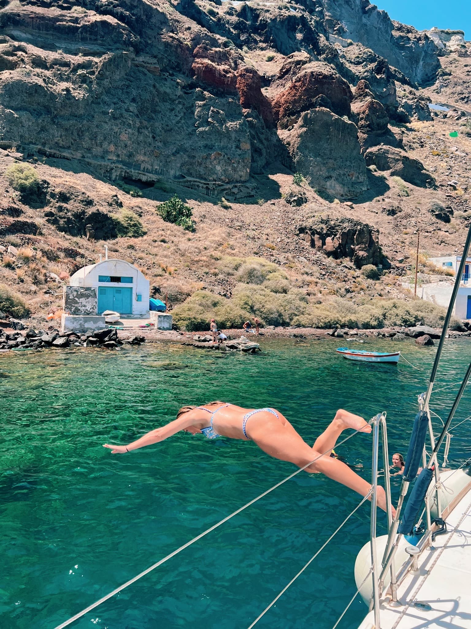 Travel advisor jumping in a lake to swim