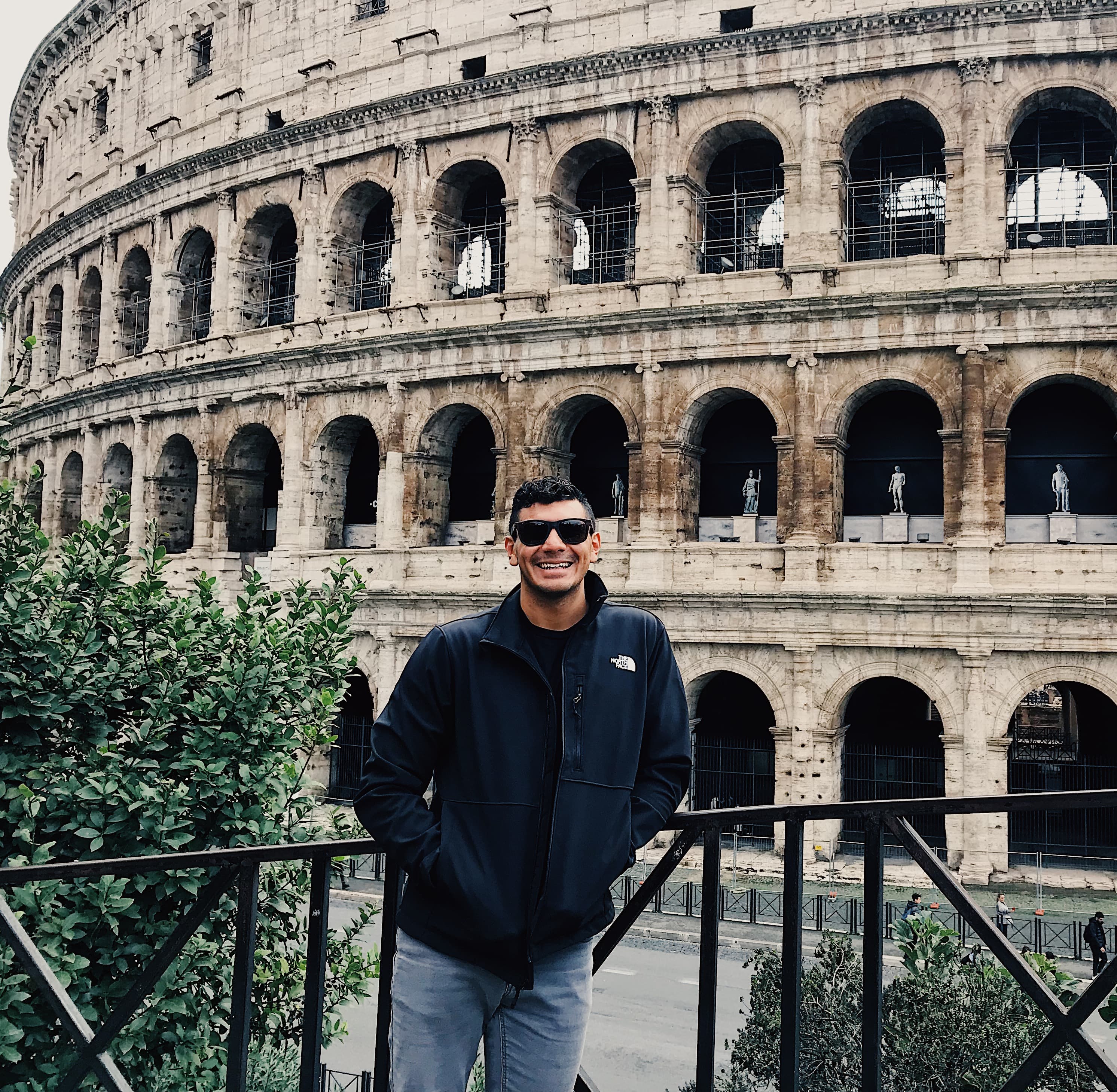Travel advisor in black jacket posing in front of an ancient place