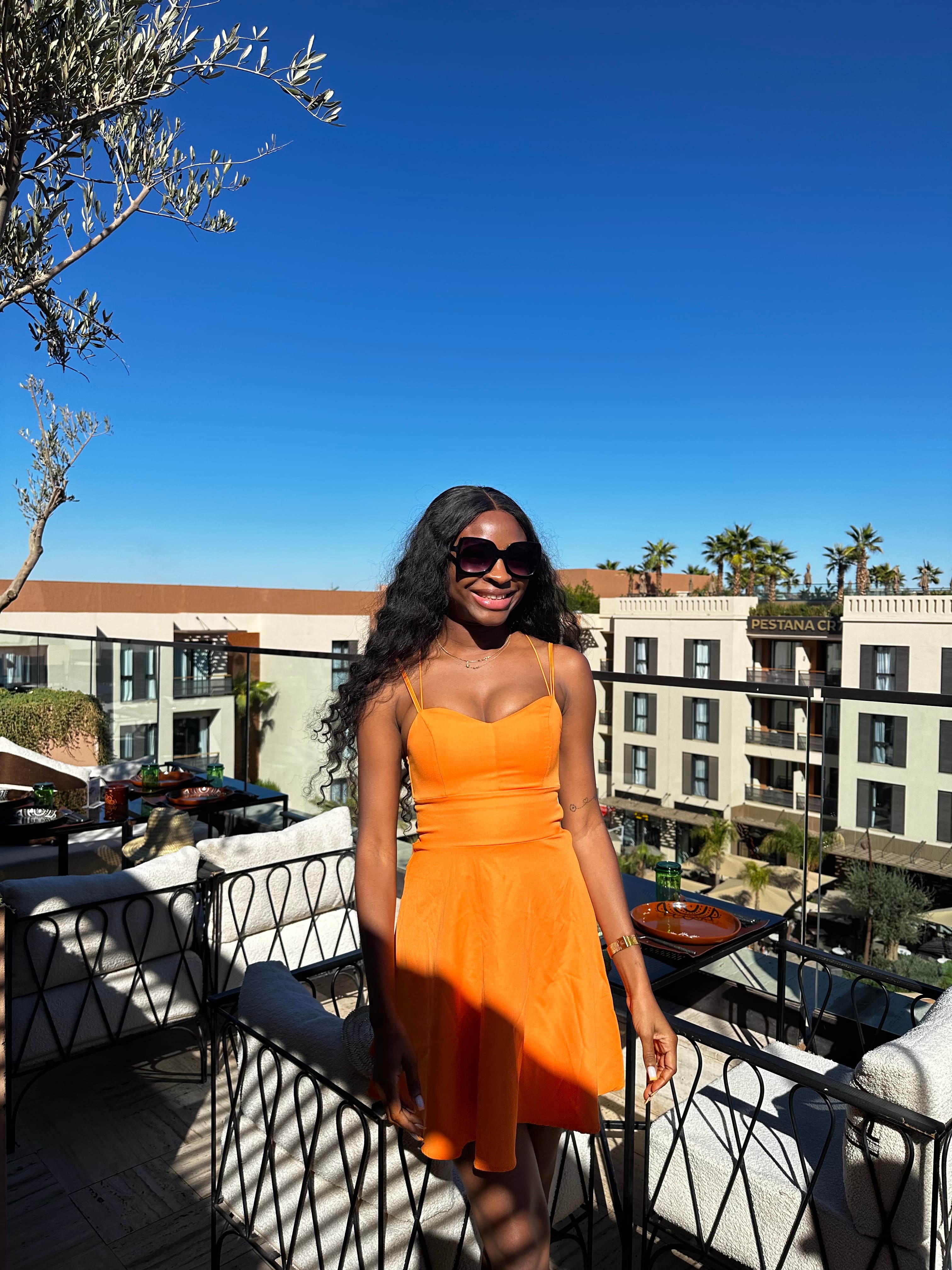 maryann in yellow dress on balcony