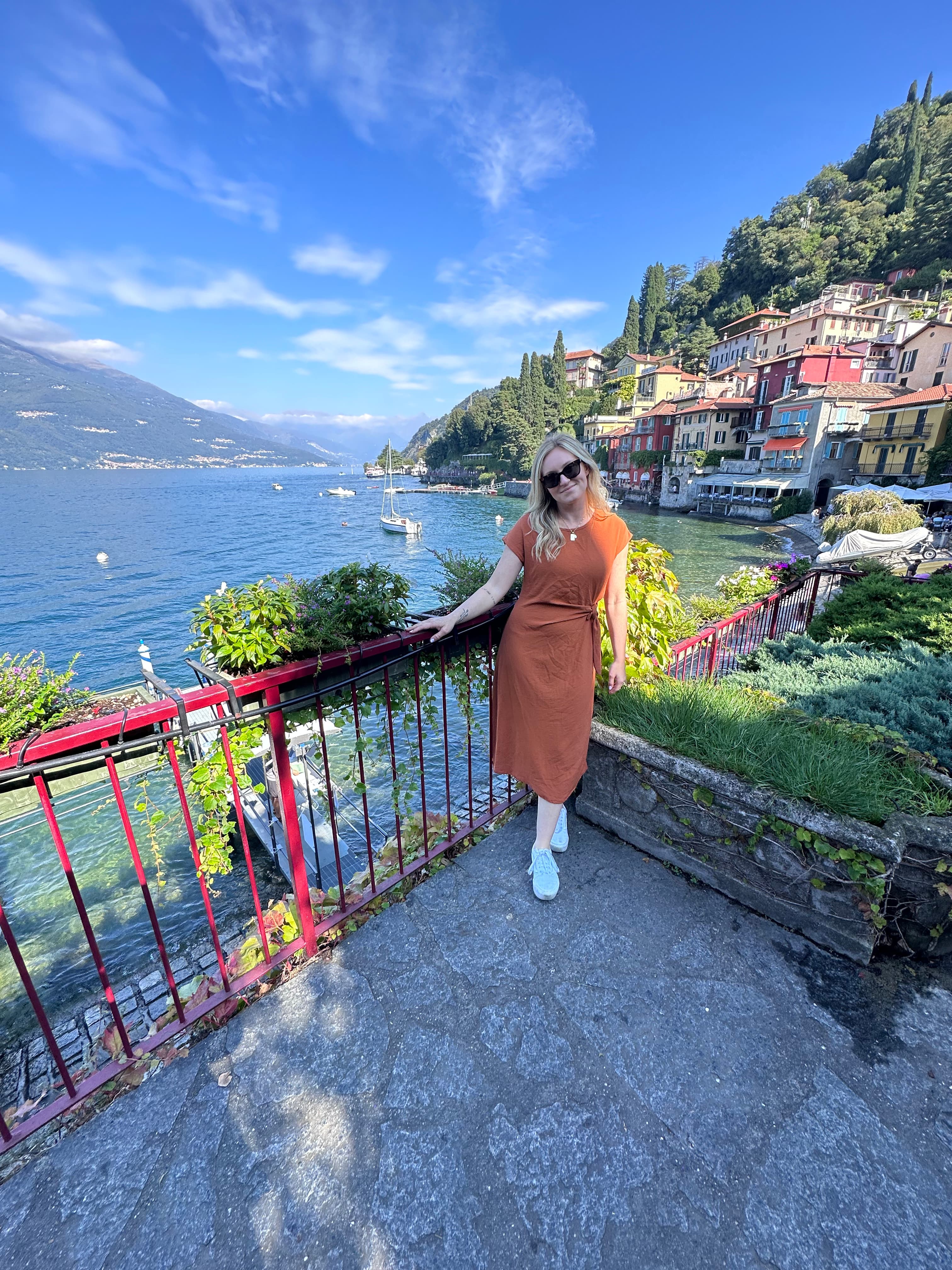 Picture of Maggie in orange dress along the lake