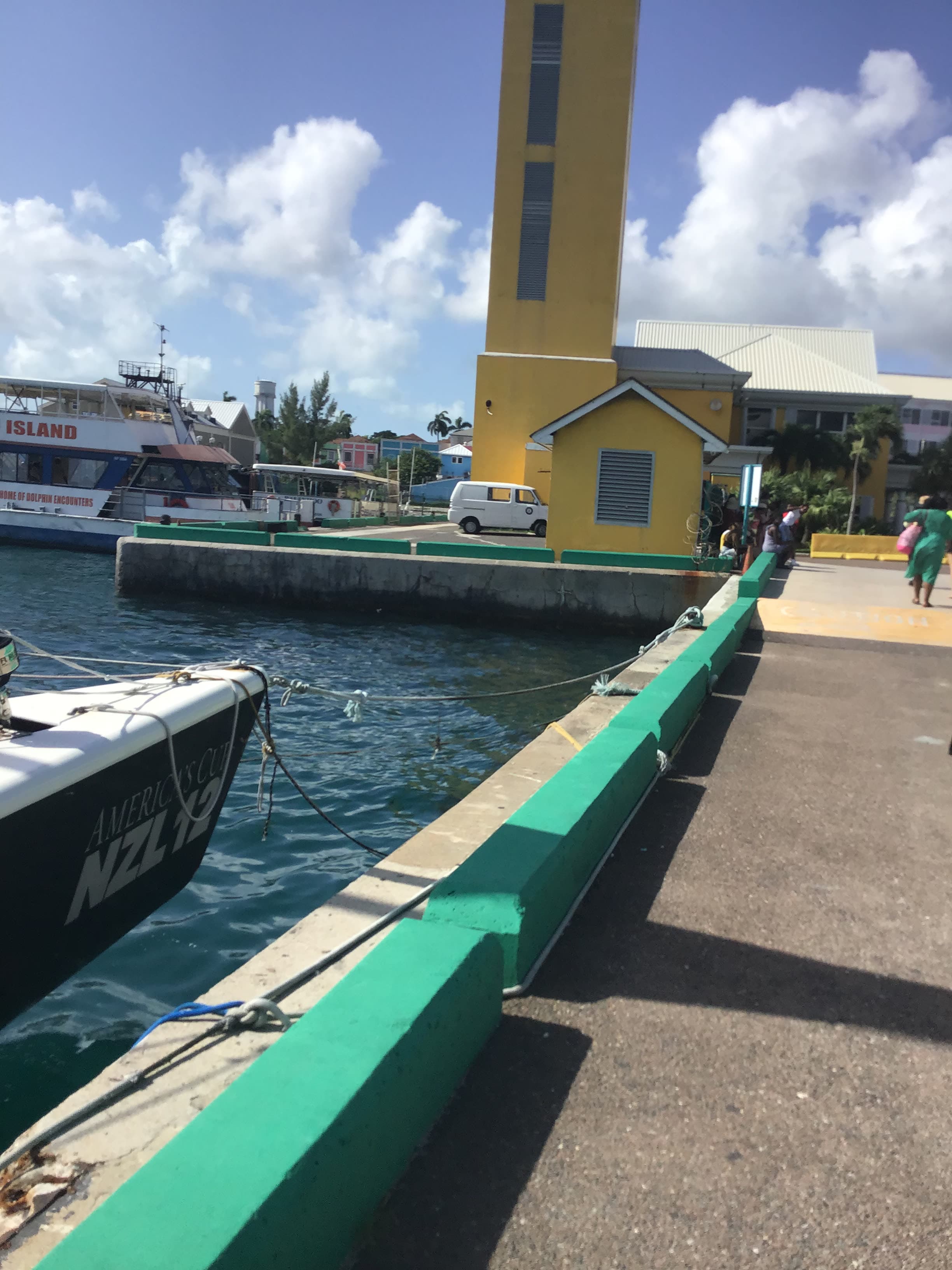 View of an empty dock at a port with a yellow building in the background