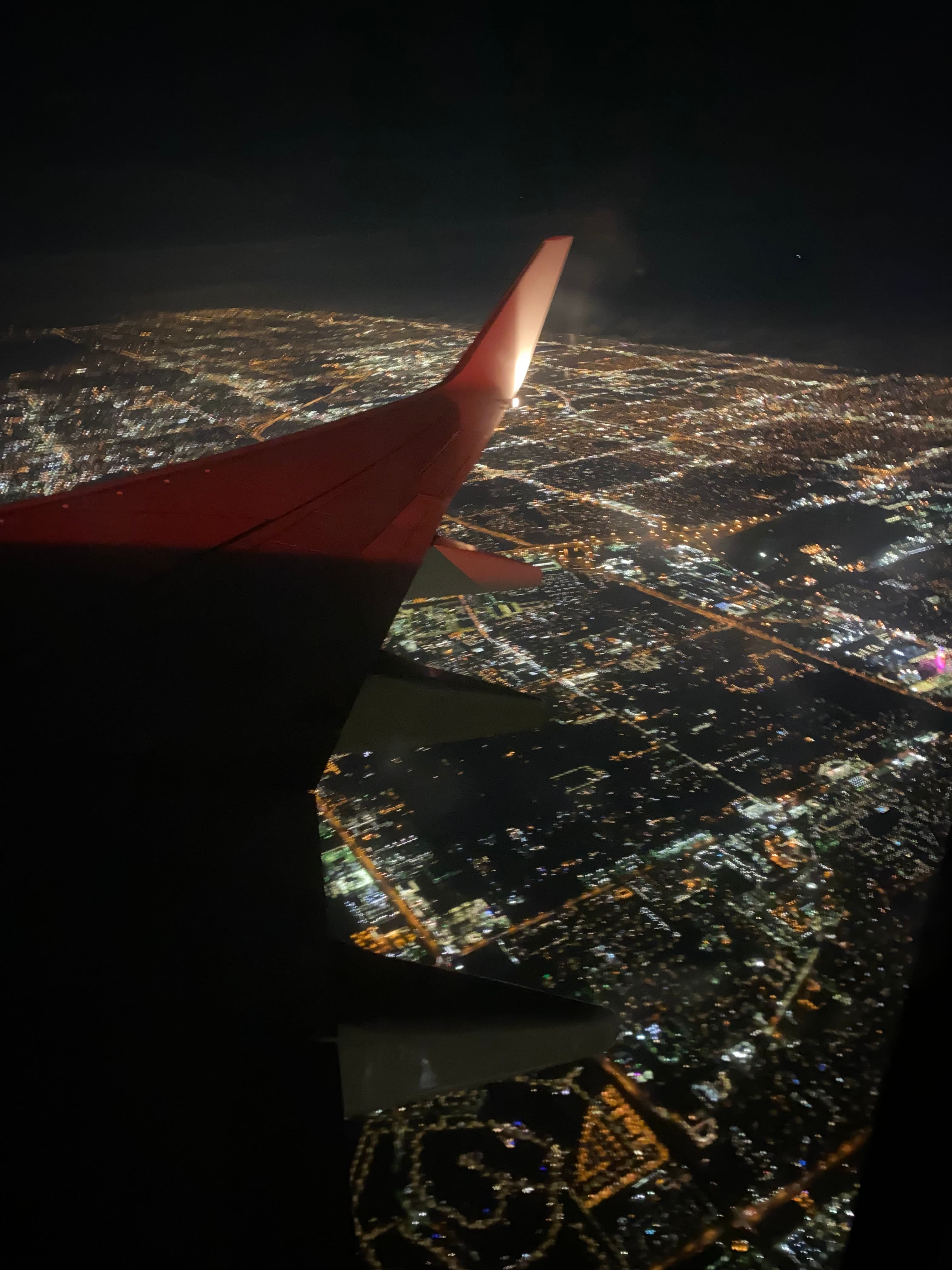 An aerial view of city at night from plane