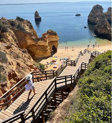 Jordan walking down stairs to Praia do Camilo beach