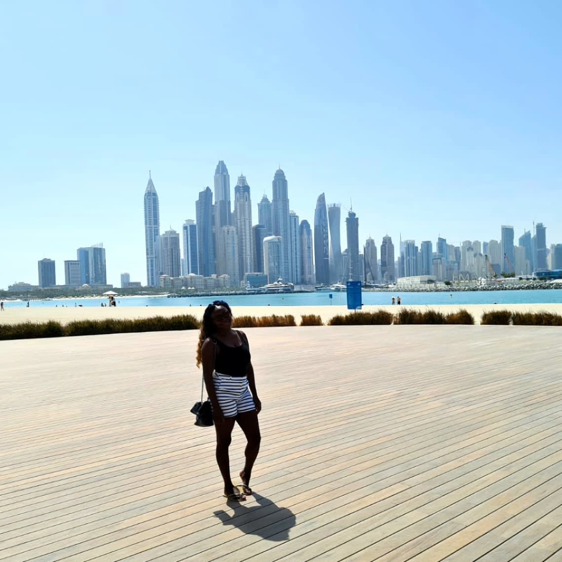 Posing for a photo with skyscrapers of Dubai in view
