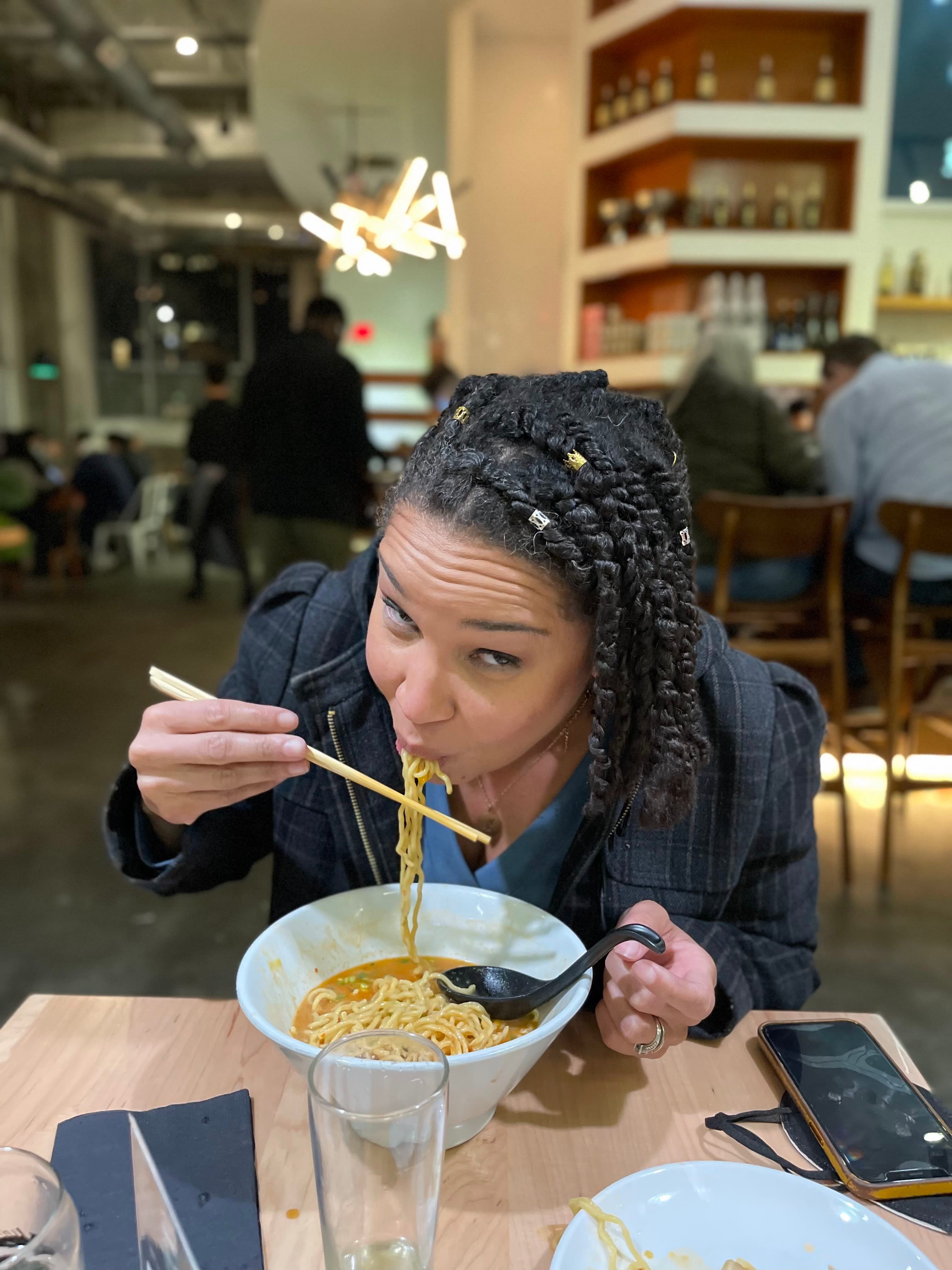 Having a bowl of ramen at a restaurant