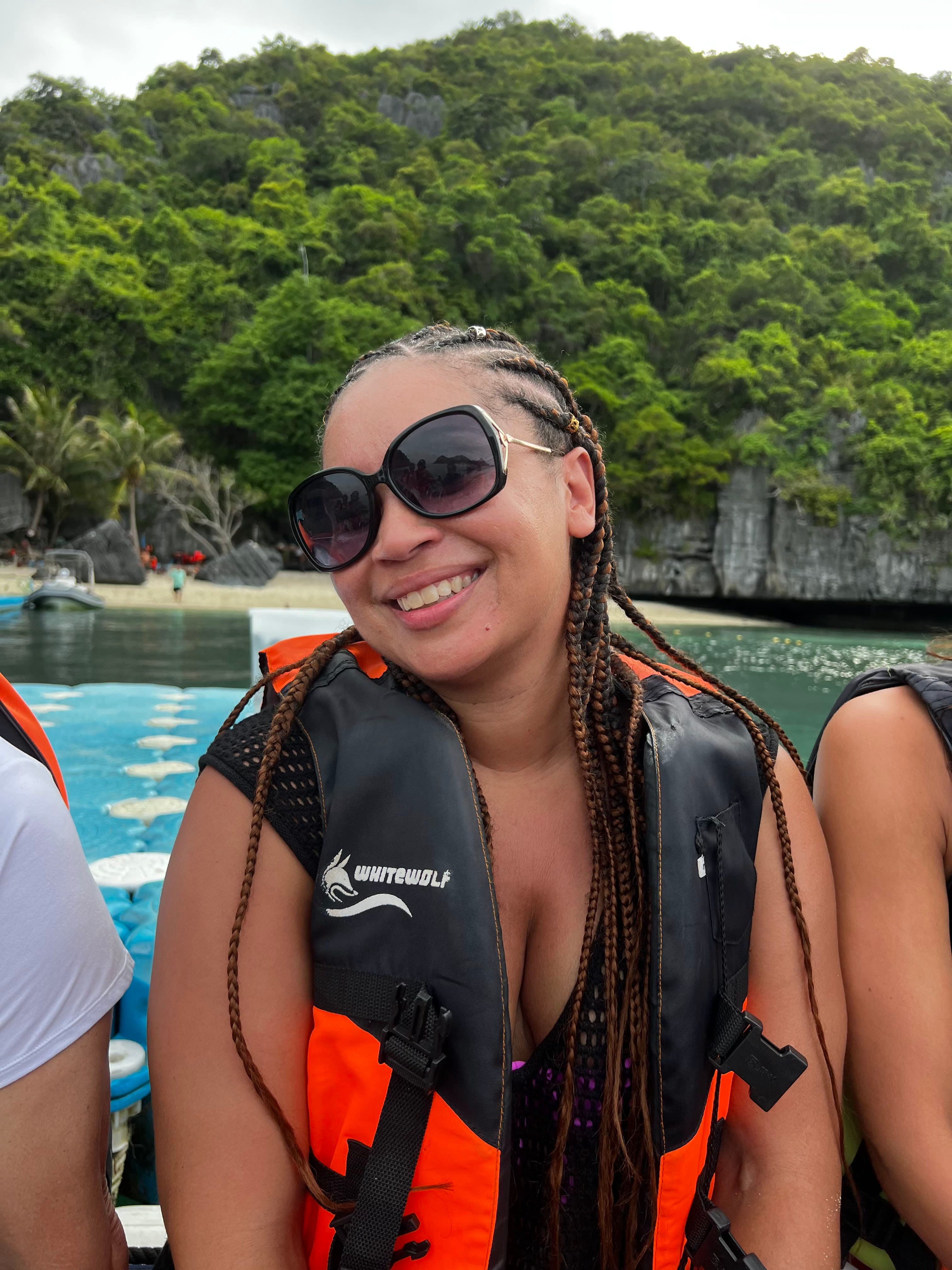 Wearing a life jacket and sitting on a boat