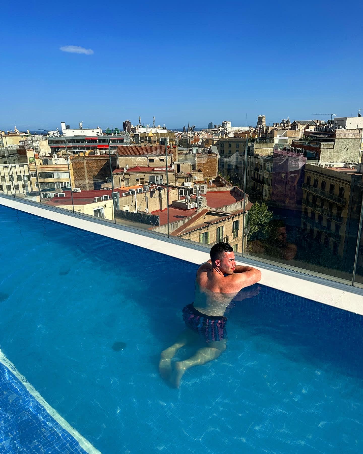 Grayson enjoying the city views from a rooftop pool
