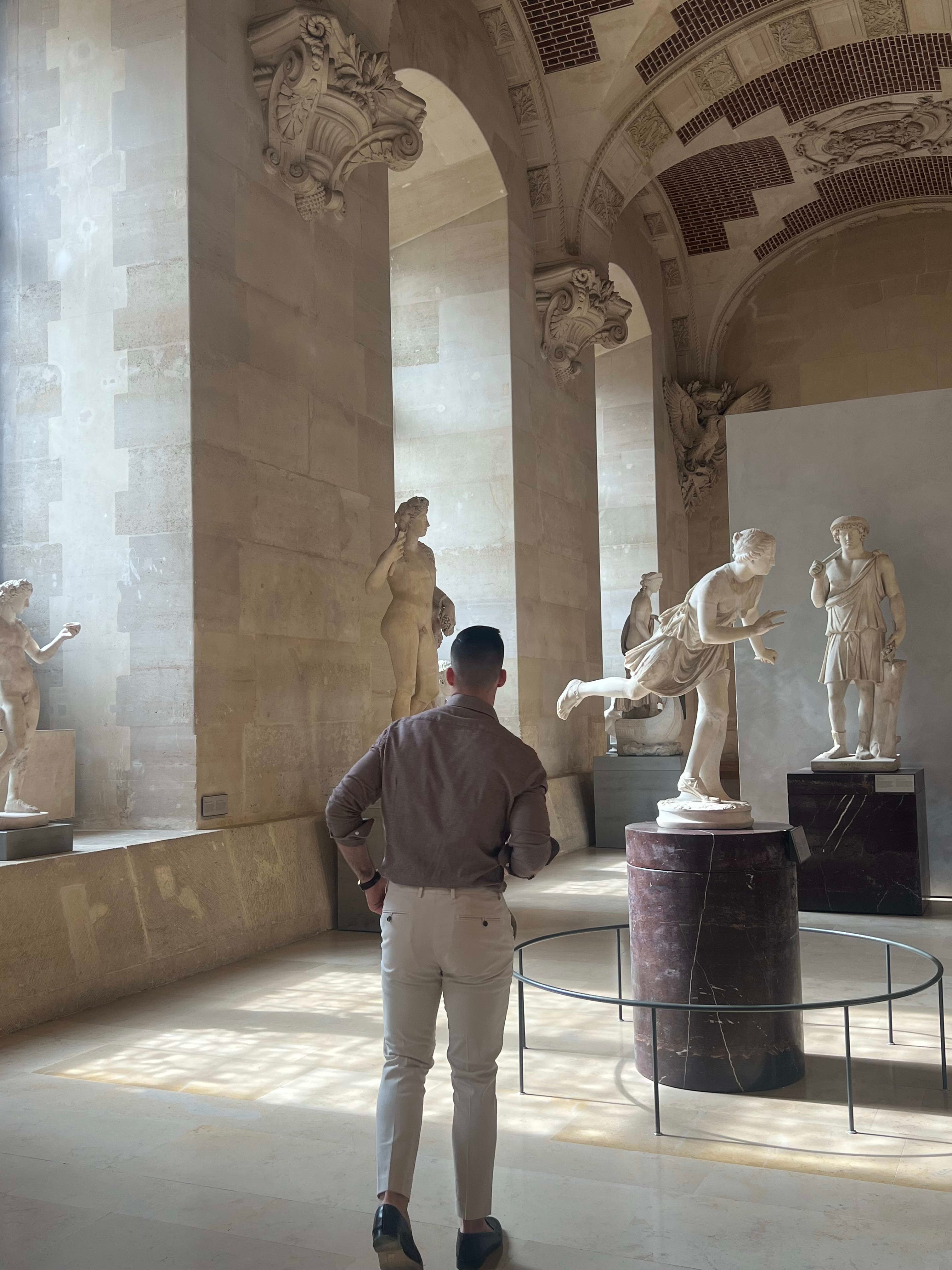 Grayson looking at the Statues in the Louvre