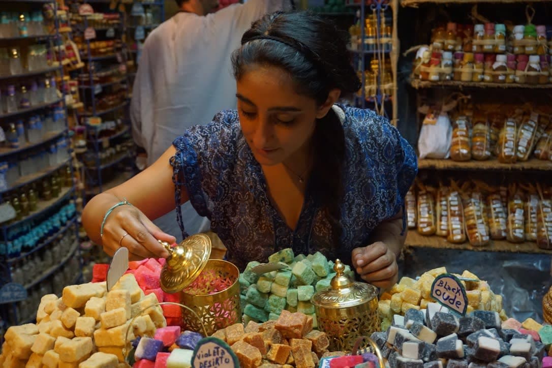 Aashima looking at the fragrance bar and soaps at the shop