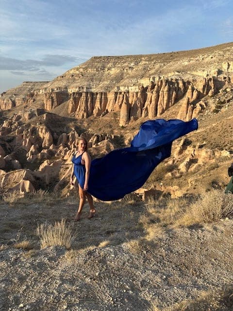 Picture of Stephanie in blue dress with mountain view