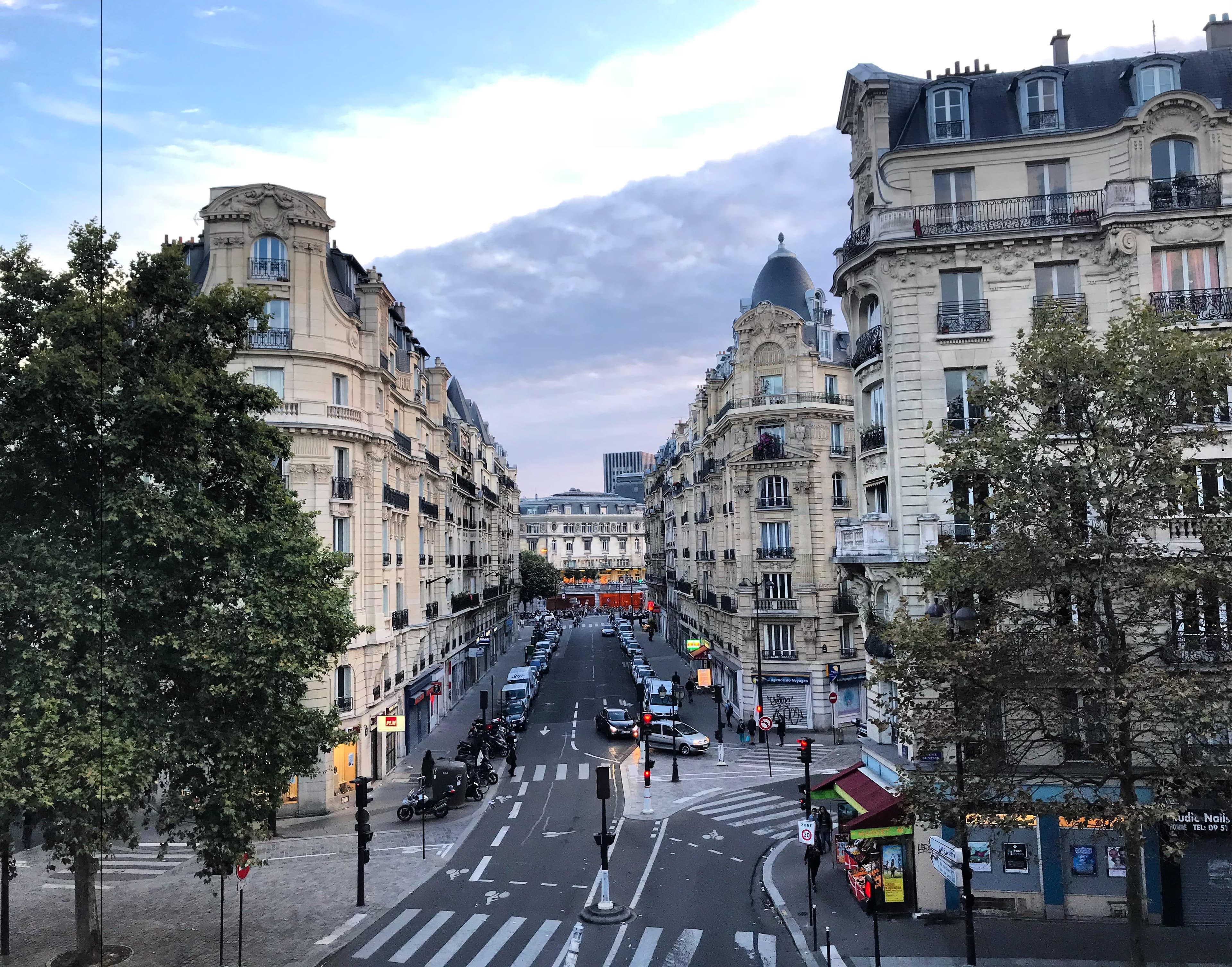 Beautiful view of Paris city roads lined with buildings and trees
