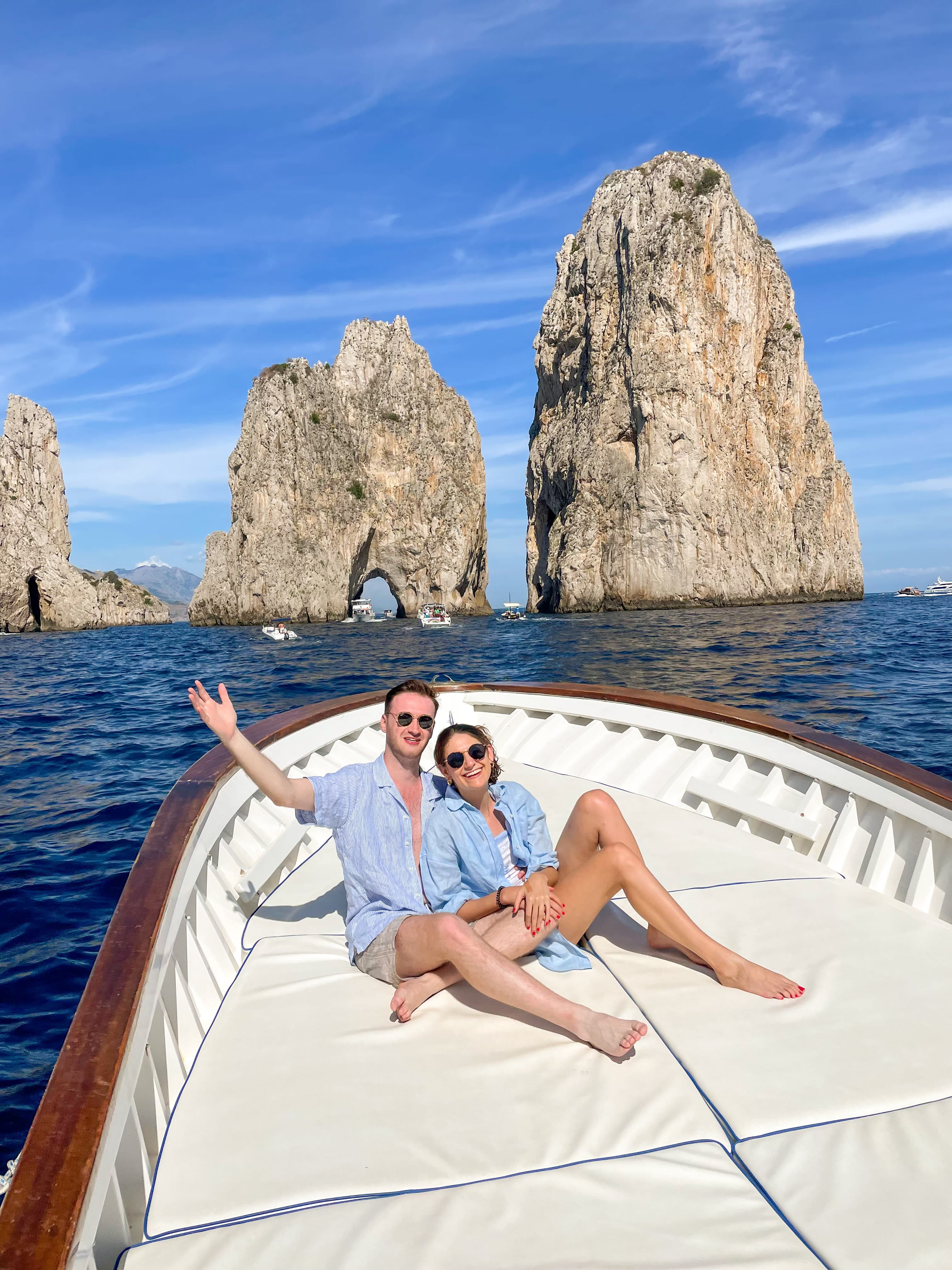 Ashely taking a private boat tour in Capri with partner, both wearing blue matching clothing