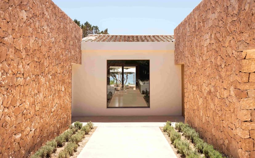 A lounge area in a hotel room with sliding balcony doors.