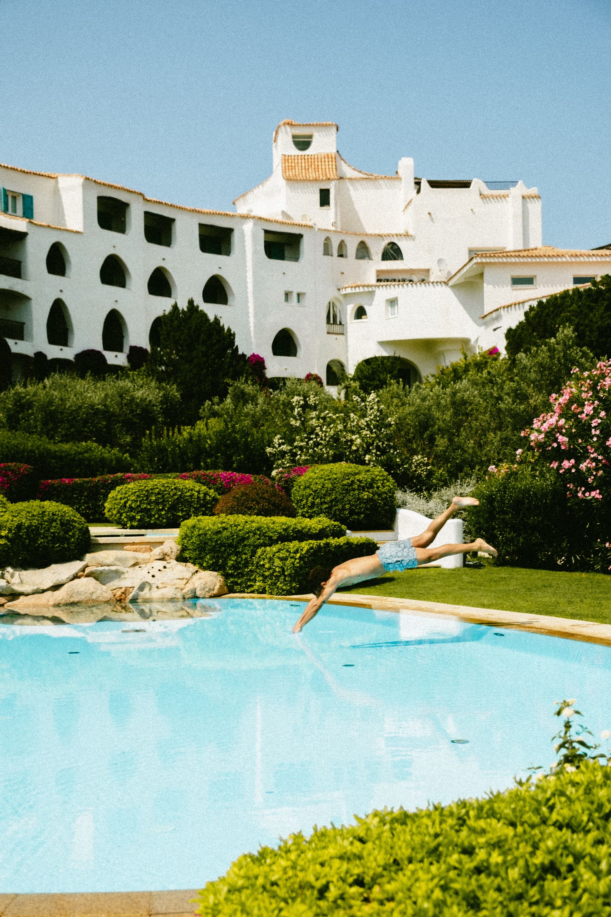 a red Italian villa hotel overlooking the sea