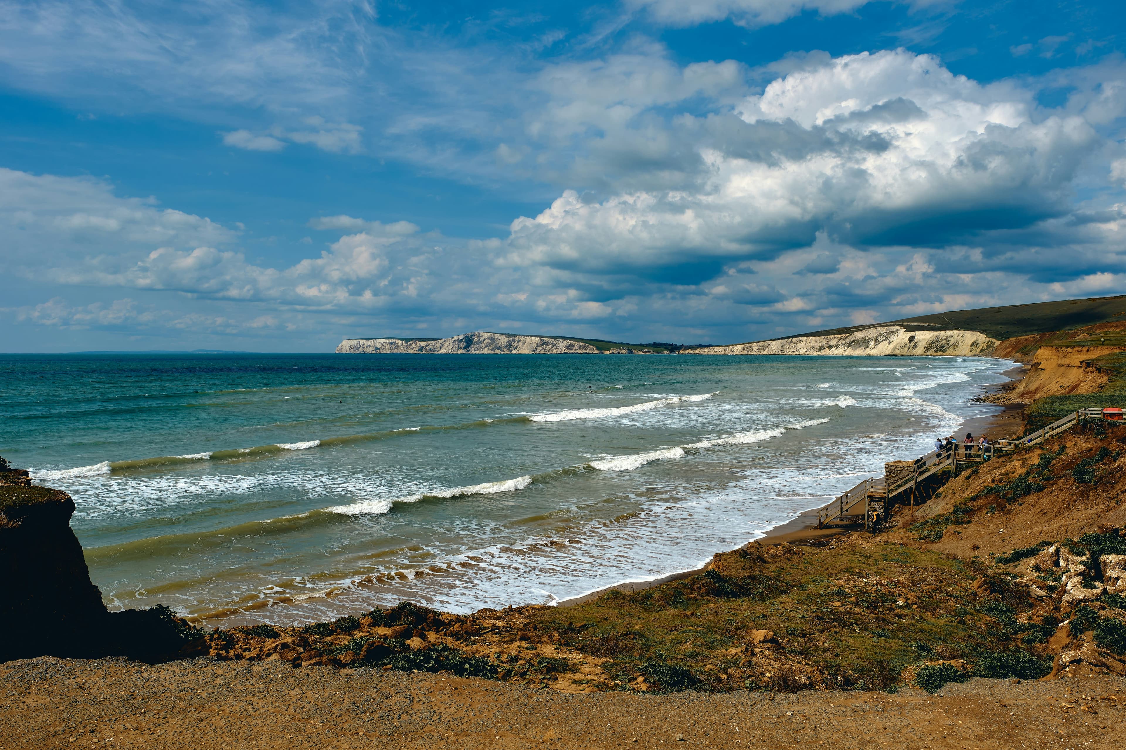 Side of a cliff overlooking beach during daytime