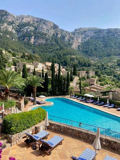 View of an empty resort pool in the mountains on a sunny day