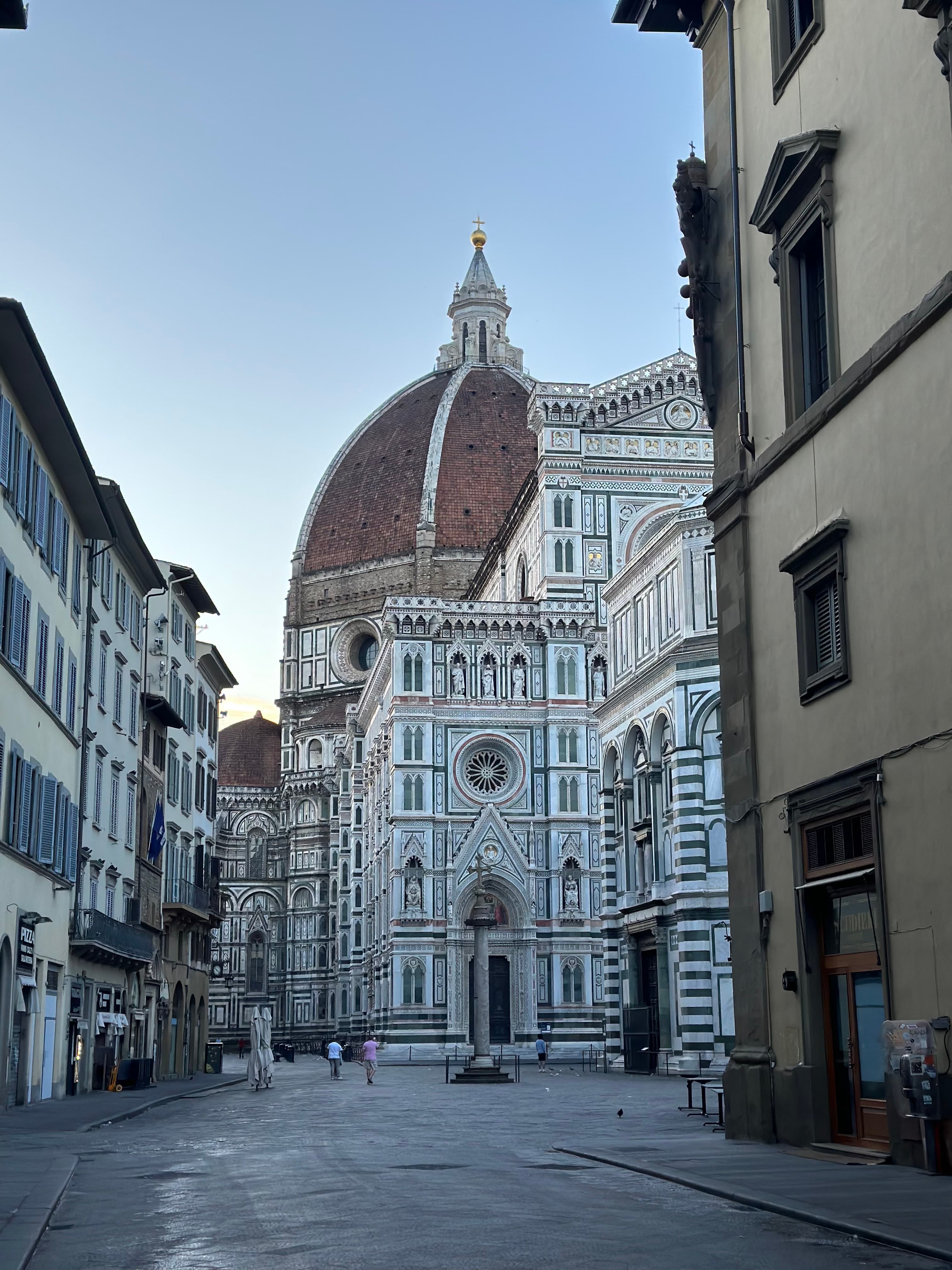 A beautiful view at dusk of a dome and classic buildings in the distance.