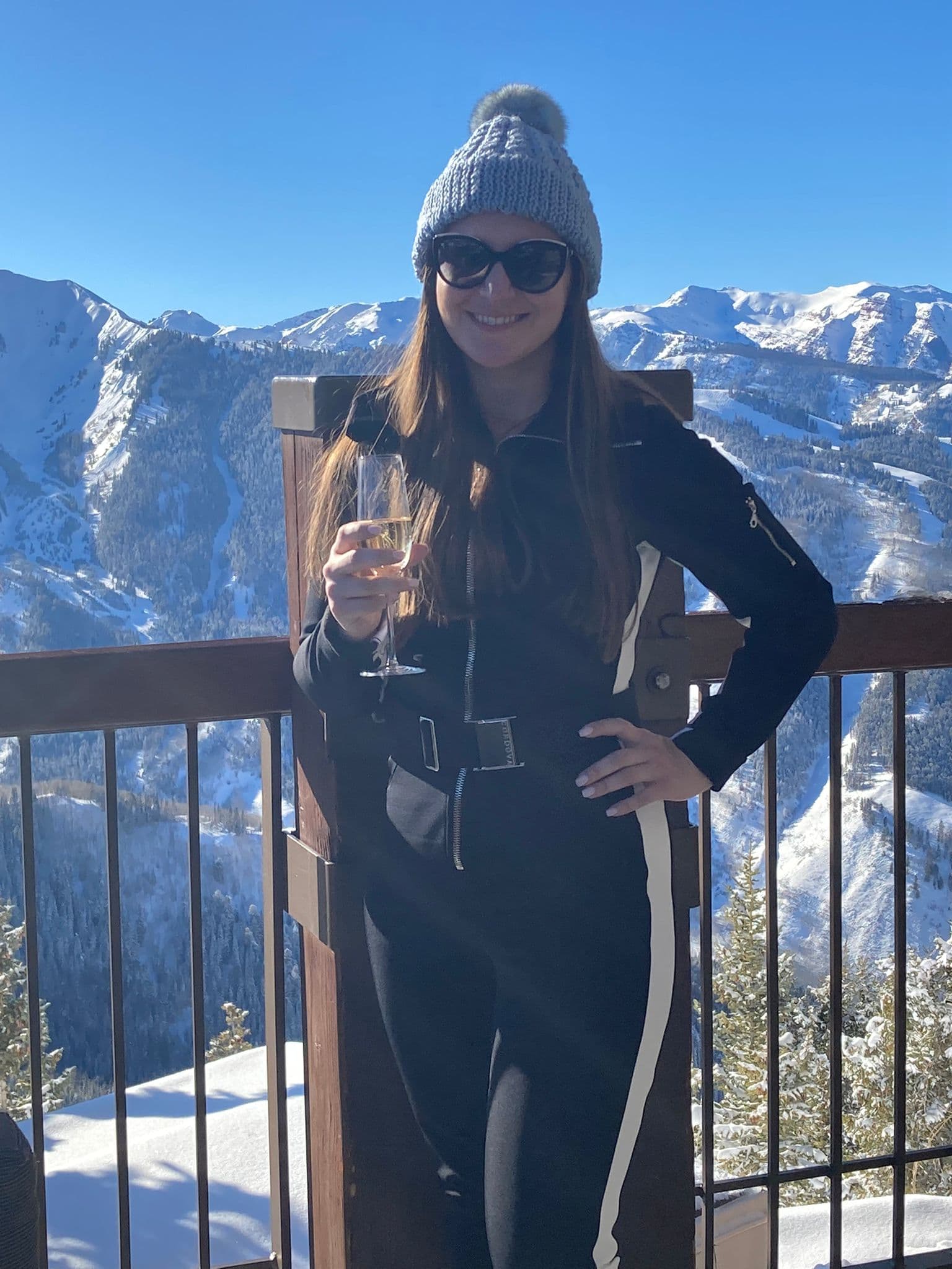 Advisor posing for an image in a cold region with snow covered mountains on a sunny day.