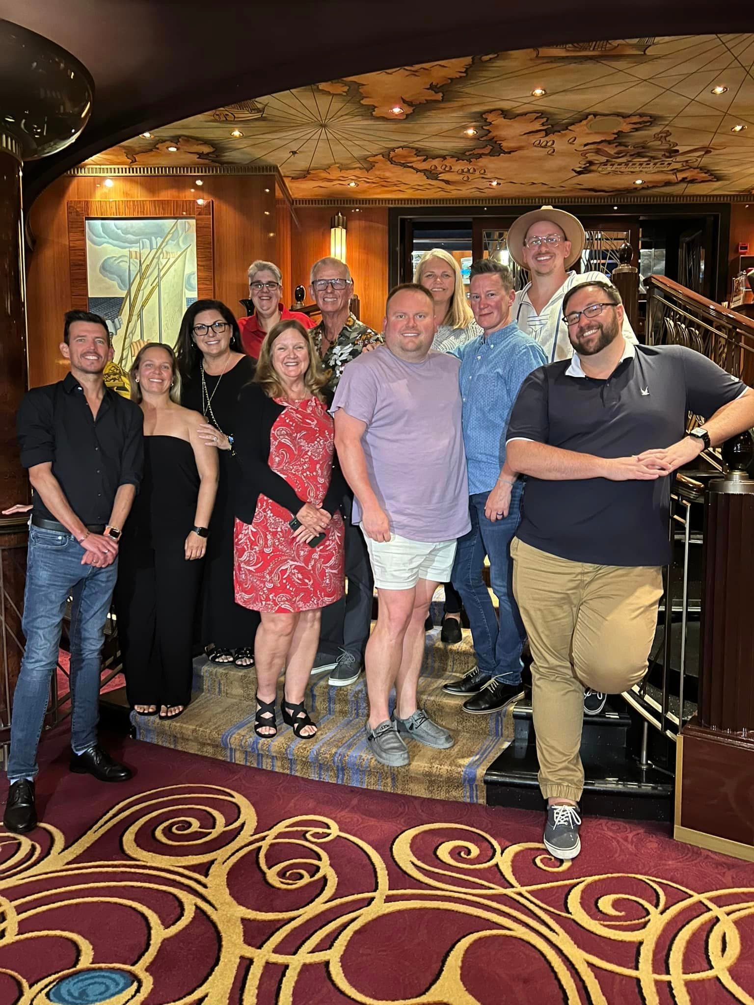 A group of friends smiling gathered together indoors.