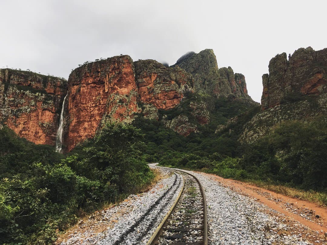 Mountain view alongside train tracks.