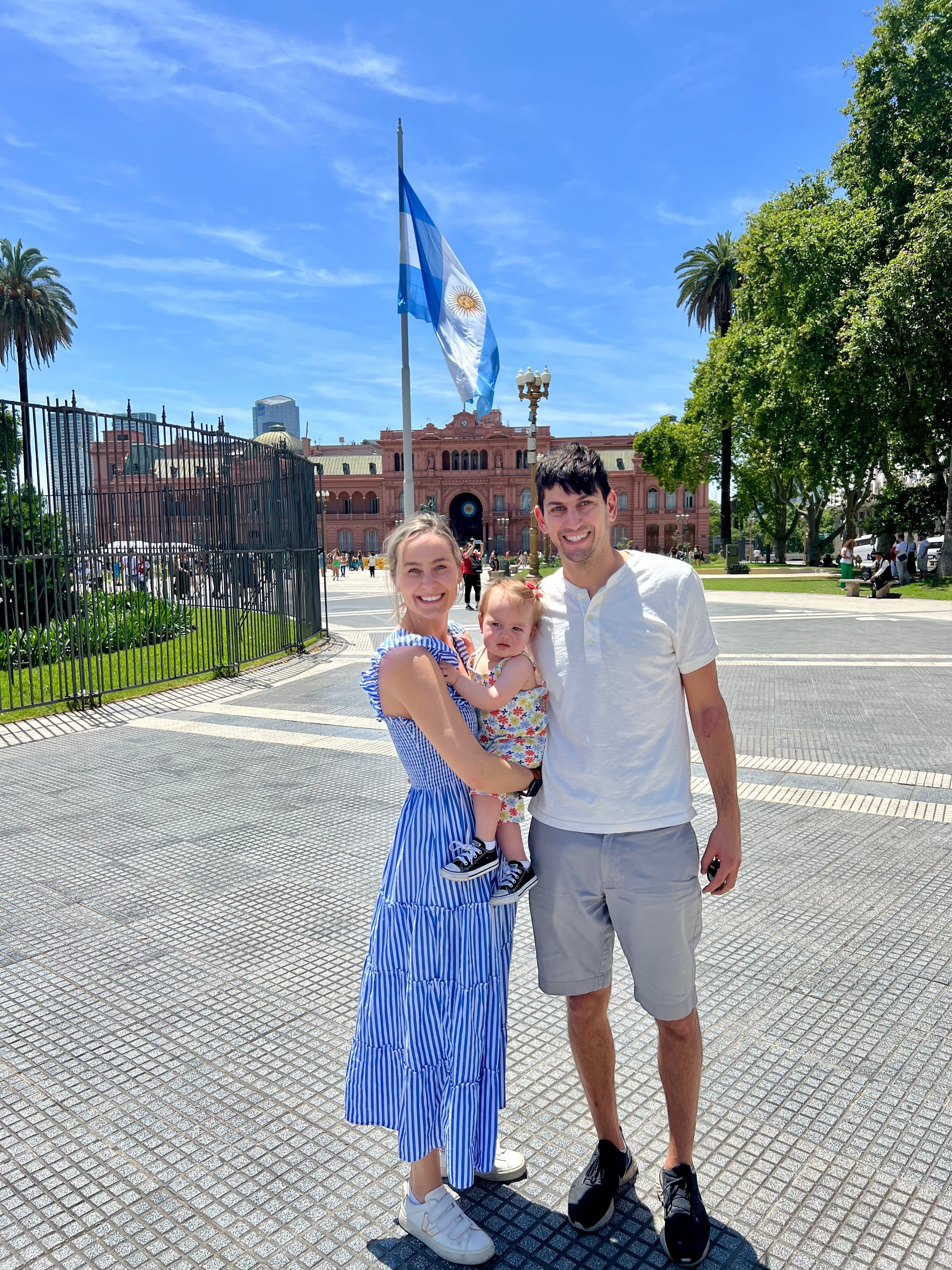 Family standing outside a grand building in Buenos Aires on a sunny day.