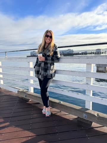 Standing in front of water views during the day.