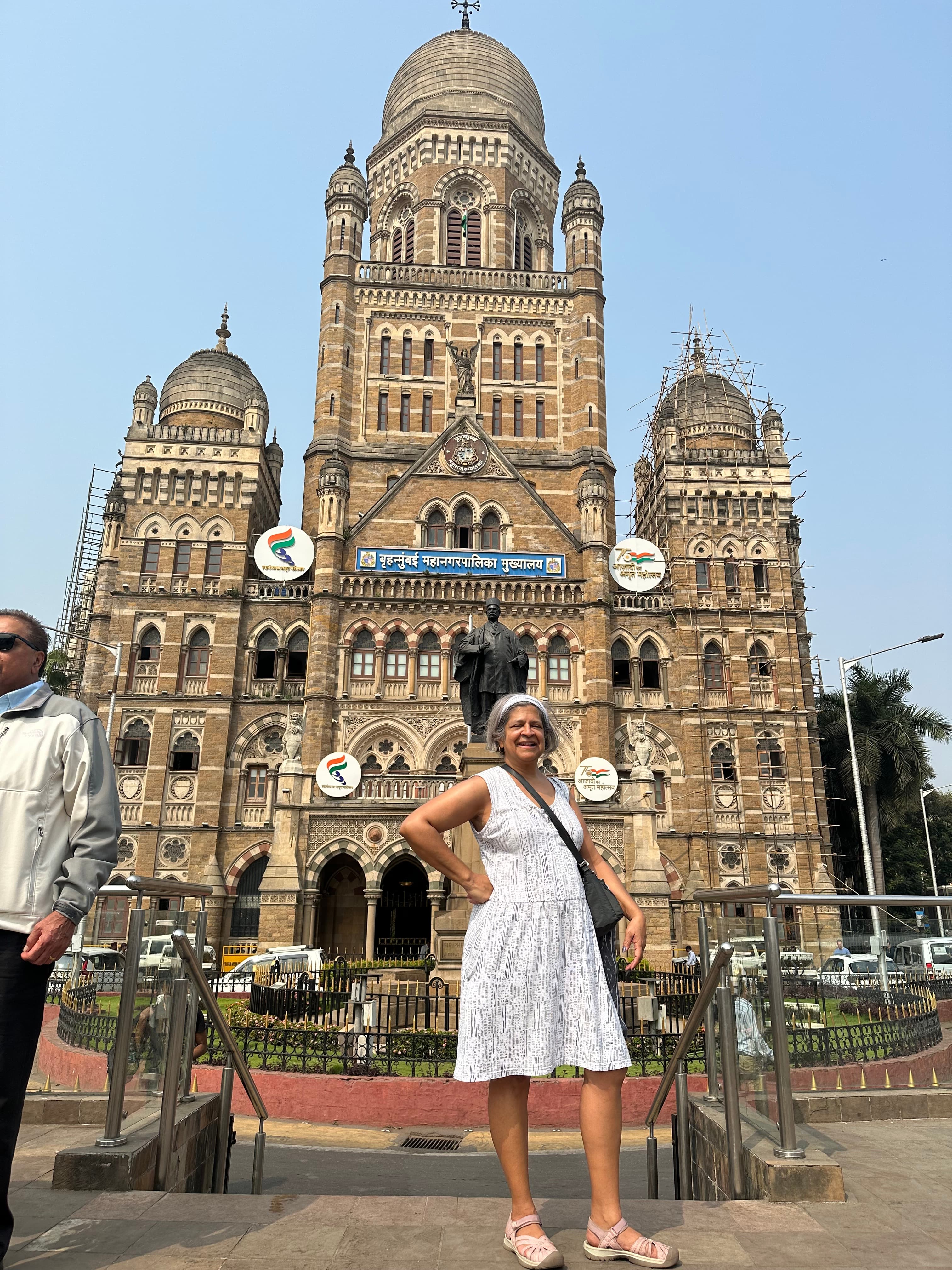 Advisor posing in front of historic building on a sunny day.