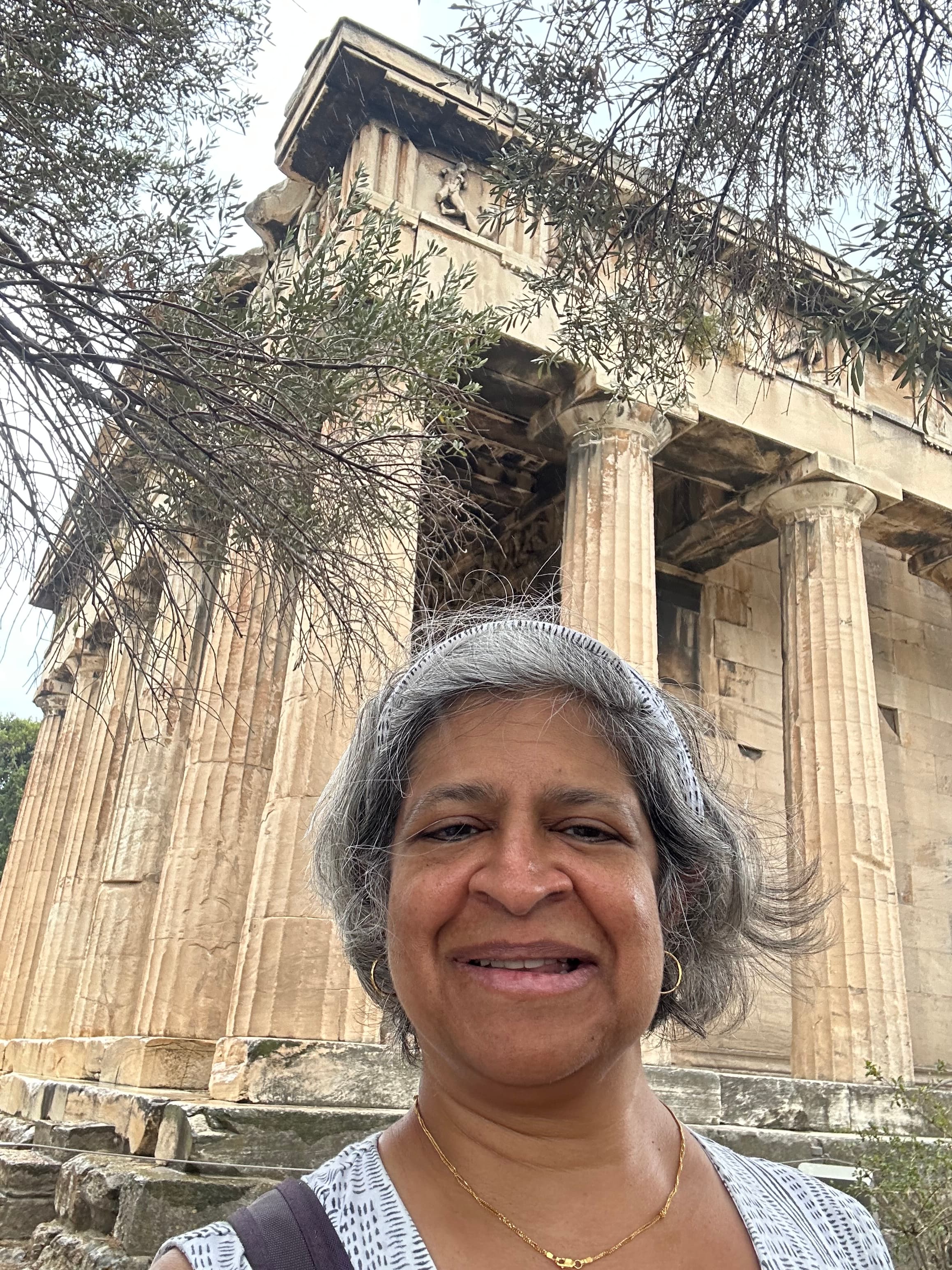 Advisor posing in front of ruins on a sunny day.