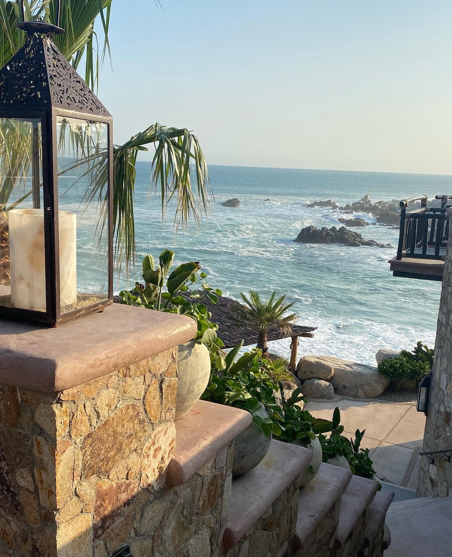 View of the ocean from the steps of a hotel during the daytime.