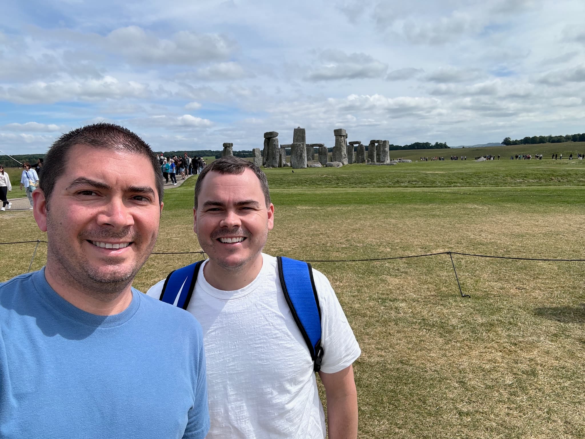 Advisor posing on a coastal hillside on a cloudy day.