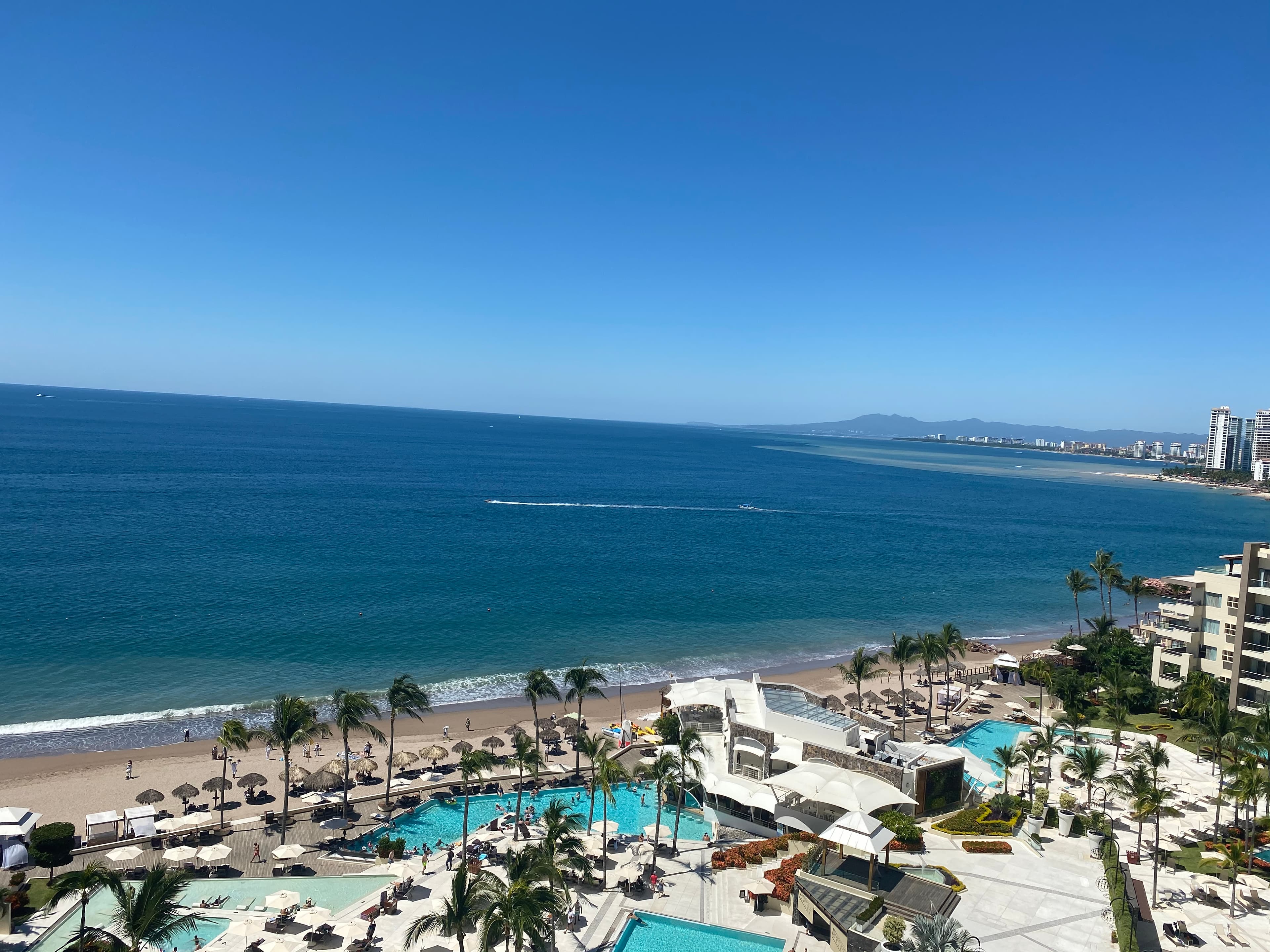 Blue skies over the beach during the day.