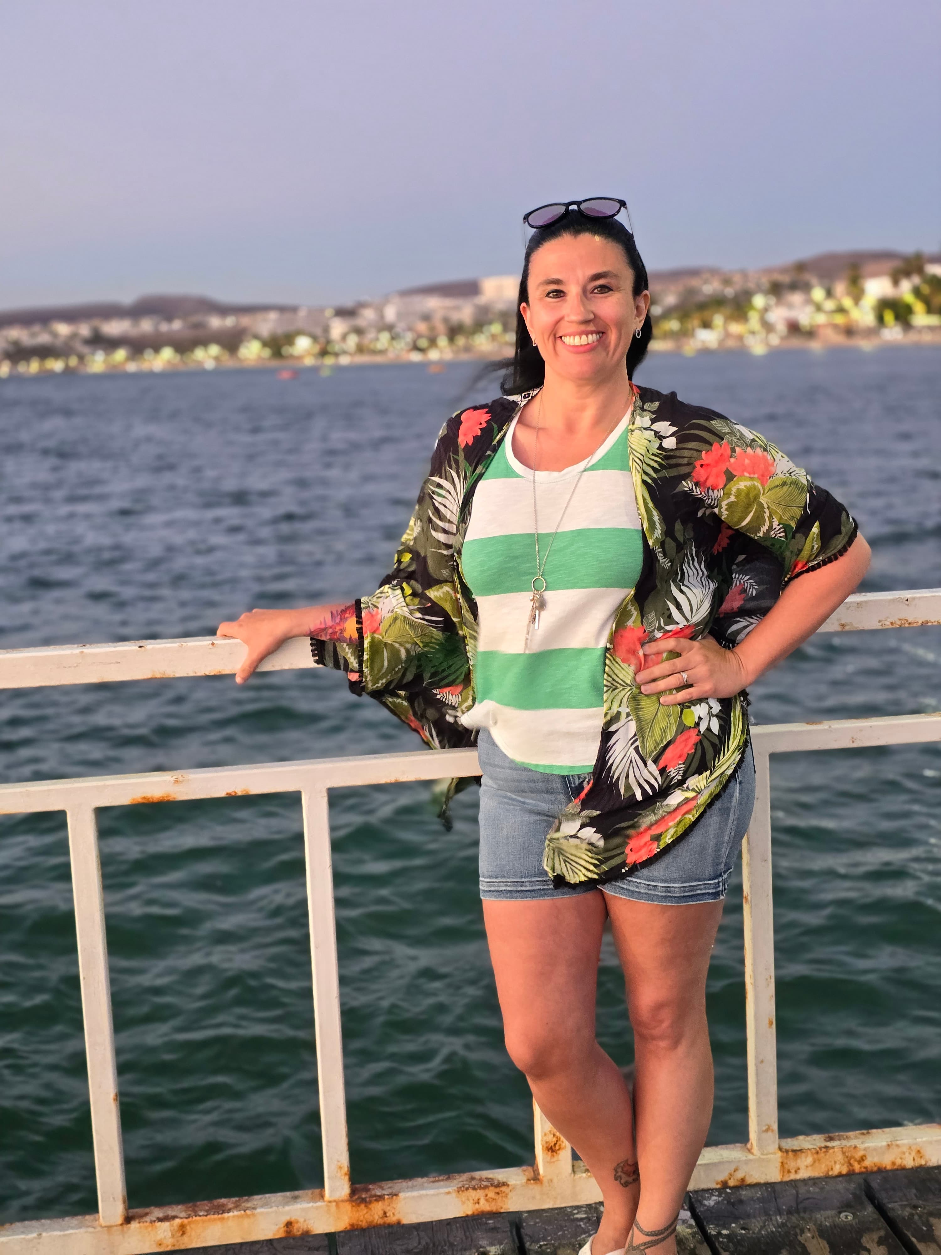 Advisor posing in front of waves lapping at dusk.