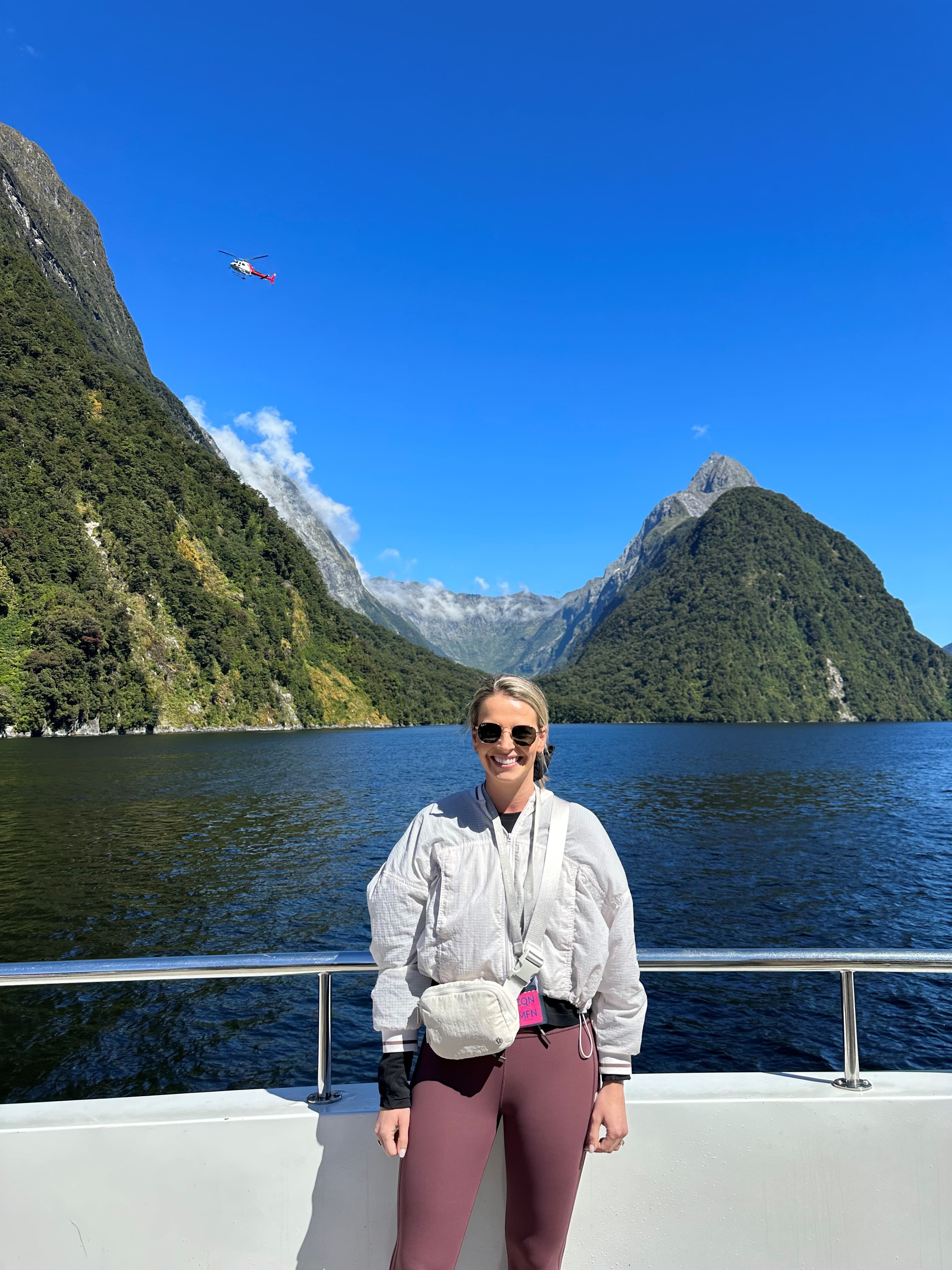 Advisor on a boat in the beautiful Milford Sound, New Zealand on a clear day