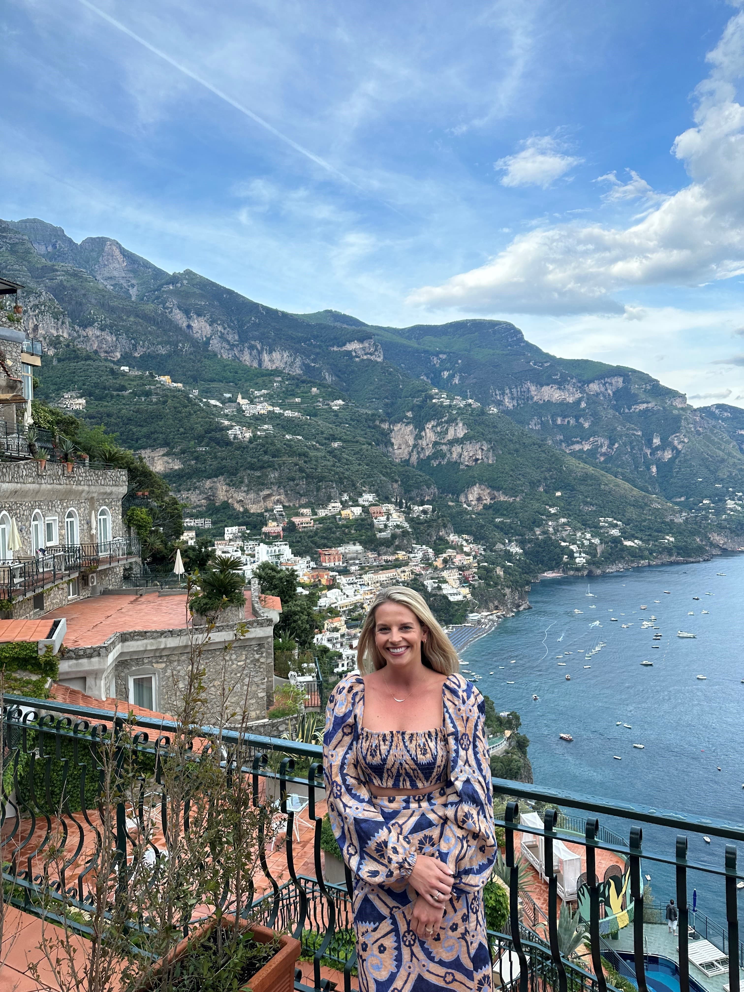 Advisor posing at a lookout point over a pretty coastal city and the sea on a sunny day