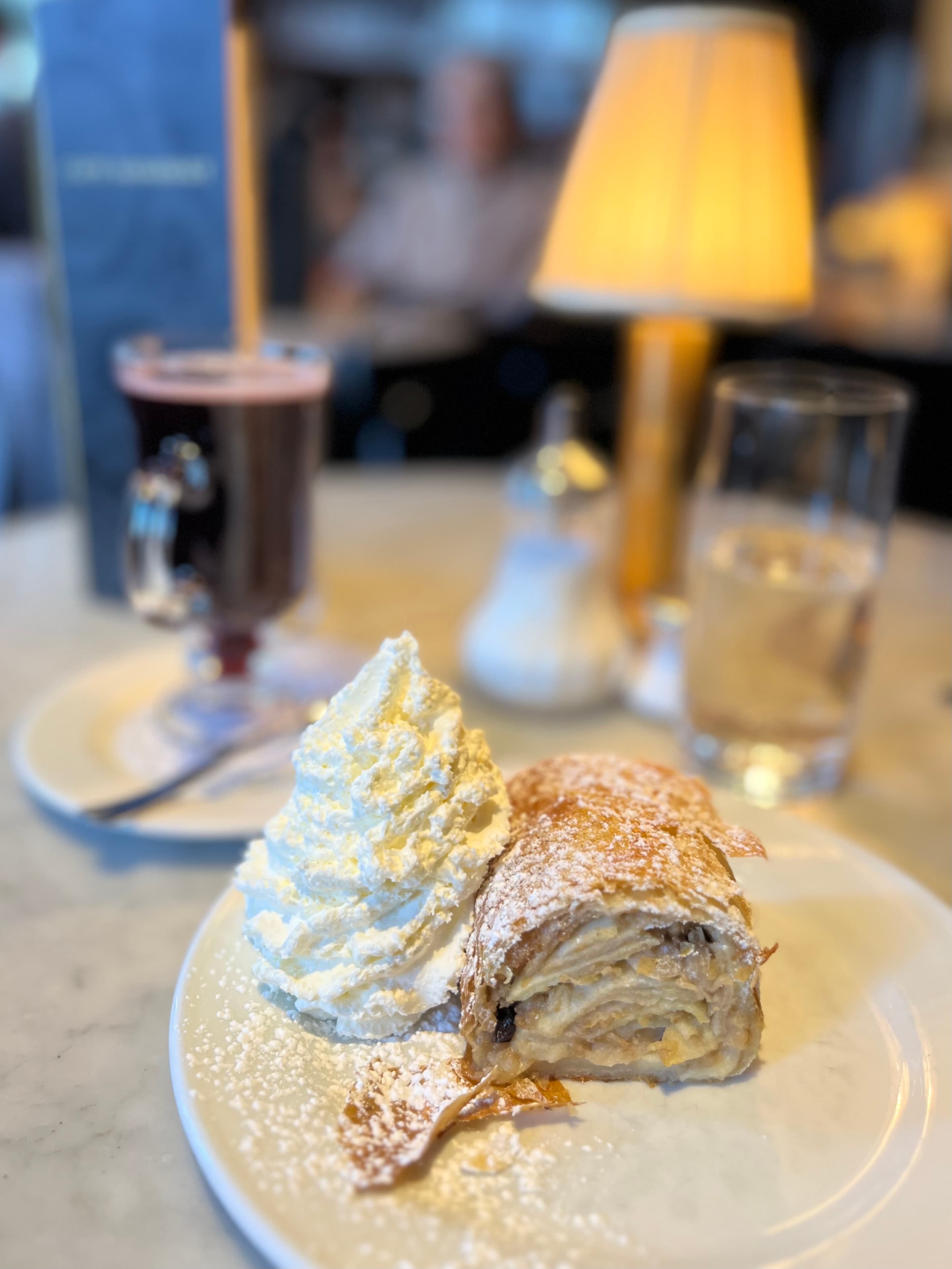 View of a dessert with whipped cream and Irish coffee on a restaurant table