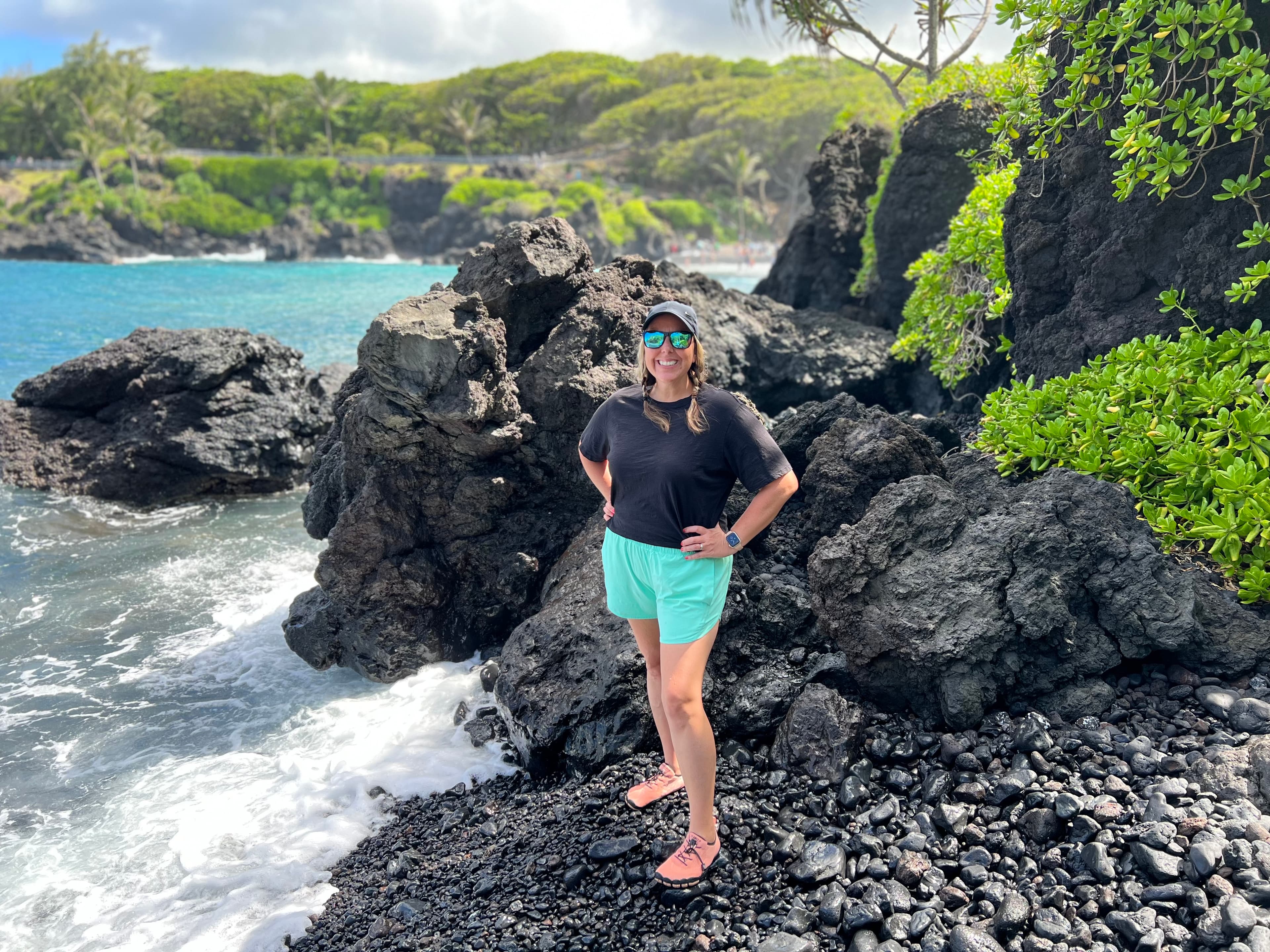 Standing on rocks by the water.