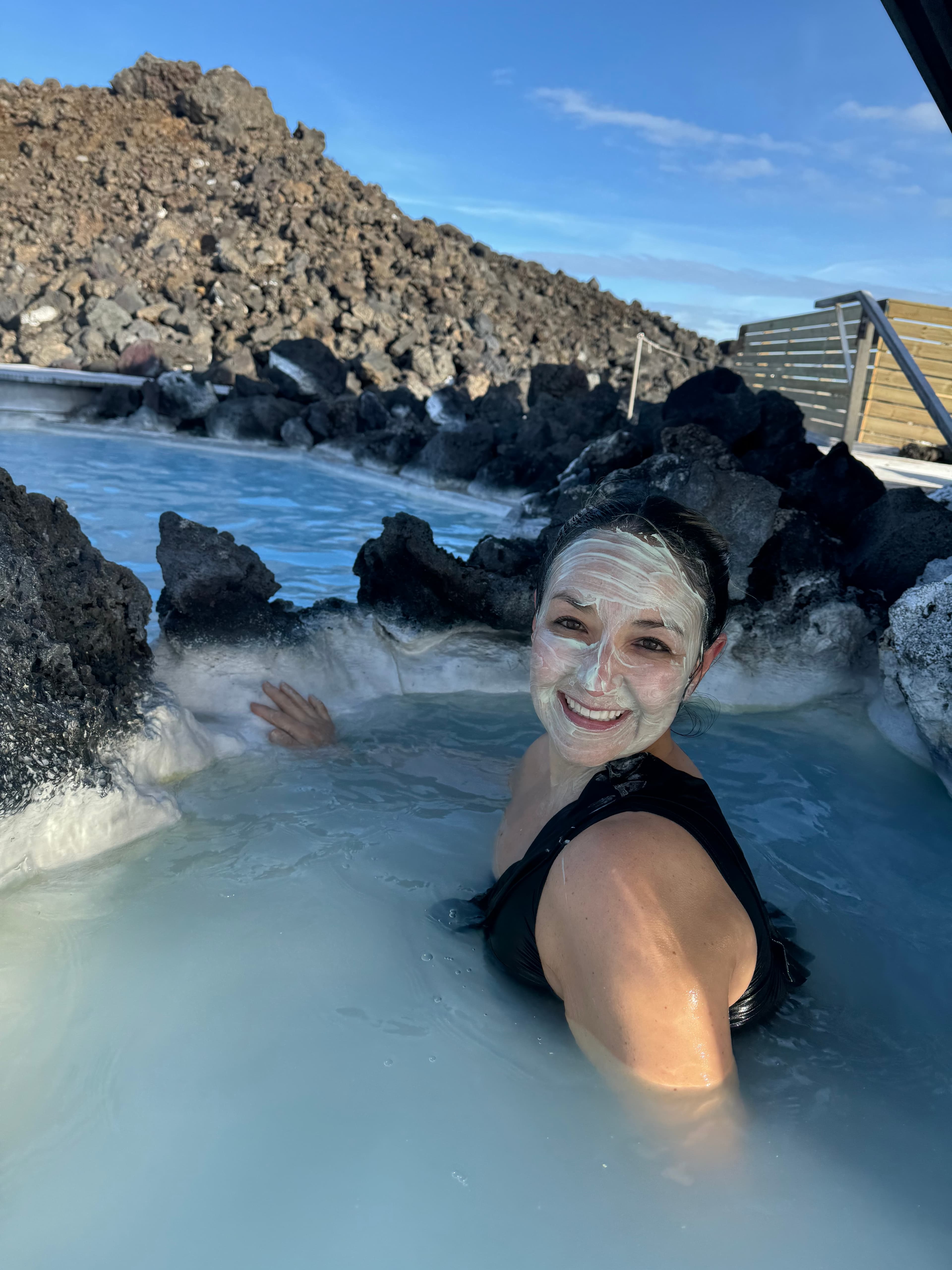 Karla in a pool, surrounded by rocks during the daytime.