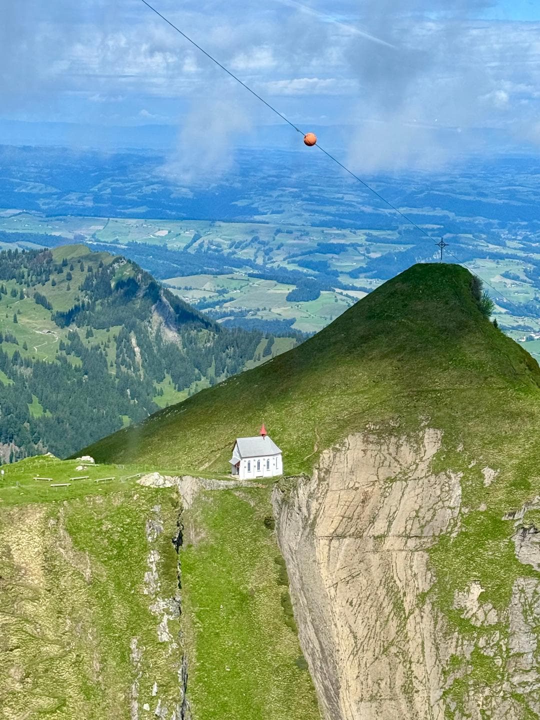 Beautiful view of a green mountain landscape and a small white house in the distance