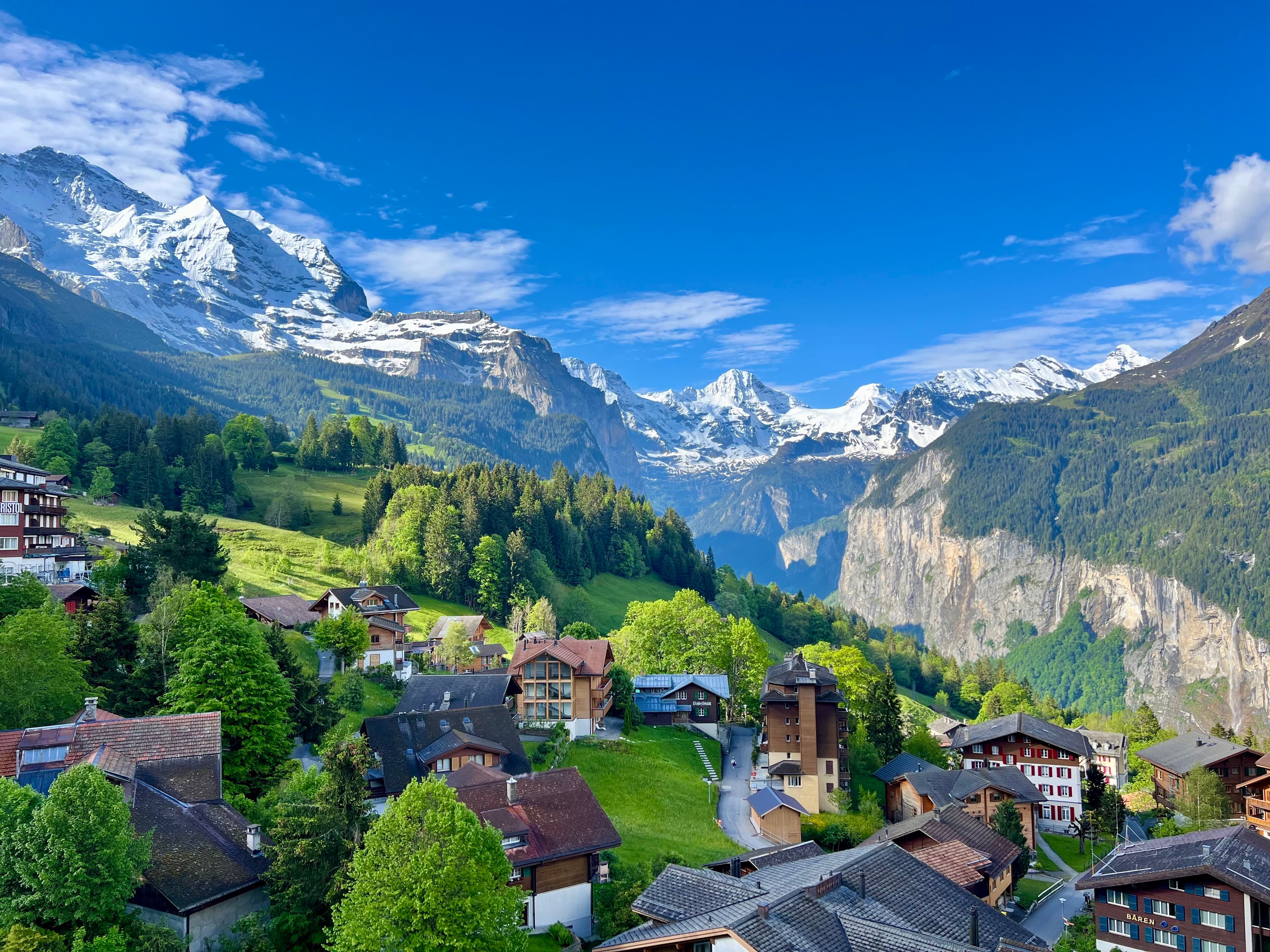Beautiful view of an alpine village with snowy mountains in the distance