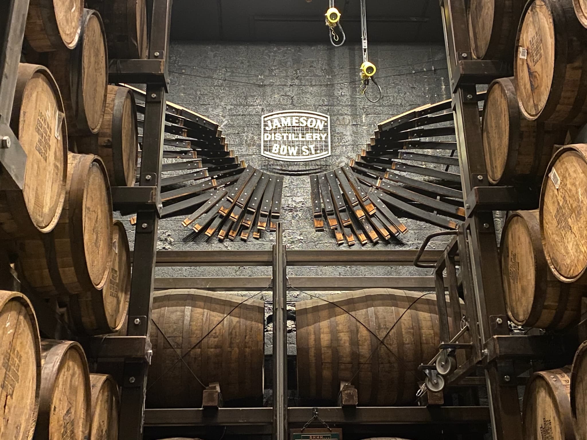 Cellar with aging oak barrels on racks.